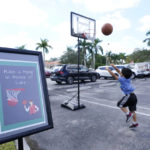 
              A young boy plays basketball, Tuesday, Feb. 14, 2023, at a ceremony in Coral Springs, Fla., honoring the lives of the 17 students and staff of Marjory Stoneman Douglas High School that were killed on Valentine's Day, 2018. Victim Luke Hoyer was passionate about basketball. (AP Photo/Wilfredo Lee)
            