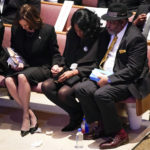 
              Vice President Kamala Harris, left, holds the hand of RowVaughn Wells as she is held by her husband Rodney Wells during the funeral service for her son Tyre Nichols at Mississippi Boulevard Christian Church in Memphis, Tenn., on Wednesday, Feb. 1, 2023.  Nichols died following a brutal beating by Memphis police after a traffic stop.  (Andrew Nelles/The Tennessean via AP, Pool)
            