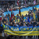 
              People attend a demonstration against Russia's war on Ukraine to mark the first anniversary of Russia's full-scale invasion of Ukraine, in Vilnius, Lithuania, Friday, Feb. 24, 2023. (AP Photo/Mindaugas Kulbis)
            