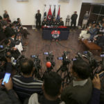 
              Pakistan's Khyber Pakhtunkhwa provincial police chief Moazzam Jan Ansari, top center, speaks during a press conference regarding the investigation of Monday's suicide bombing, in Peshawar, Pakistan, Feb. 2, 2023. A suicide bomber who killed 101 people at a mosque in northwest Pakistan this week had disguised himself in a police uniform and did not raise suspicion among guards, the provincial police chief said on Thursday. (AP Photo/Muhammad Sajjad)
            
