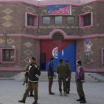 
              Police officers gather outside a police station, in Warburton, an area of district Nankana, Pakistan, Sunday, Feb. 12, 2023. Hundreds of Muslims descended on a police station in Pakistan's eastern Punjab province on Saturday, snatched Waris, a blasphemy suspect from his cell and took him outside and lynched him, police said. (AP Photo/K.M. Chaudary)
            