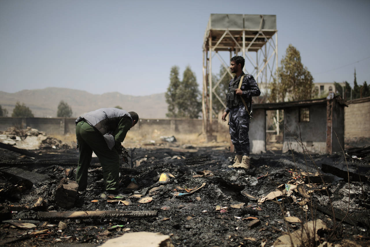 FILE - Yemeni police inspect a site of Saudi-led airstrikes targeting two houses in Sanaa, Yemen, S...