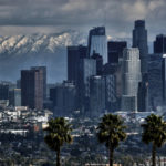 
              Storm clouds and snowfall are seen over the San Gabriel mountain range behind downtown Los Angeles on Sunday, Feb. 26, 2023. (AP Photo/Richard Vogel)
            