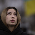 
              Anastasiia Okhrimenko, 26, reacts next to the grave of her husband Yurii Stiahliuk, a Ukrainian serviceman who died in combat on Aug. 24 in Marinka, during a memorial service to mark the one-year anniversary of the start of the Russia Ukraine war, in a cemetery in Bucha, Ukraine, Friday, Feb. 24, 2023. (AP Photo/Emilio Morenatti)
            