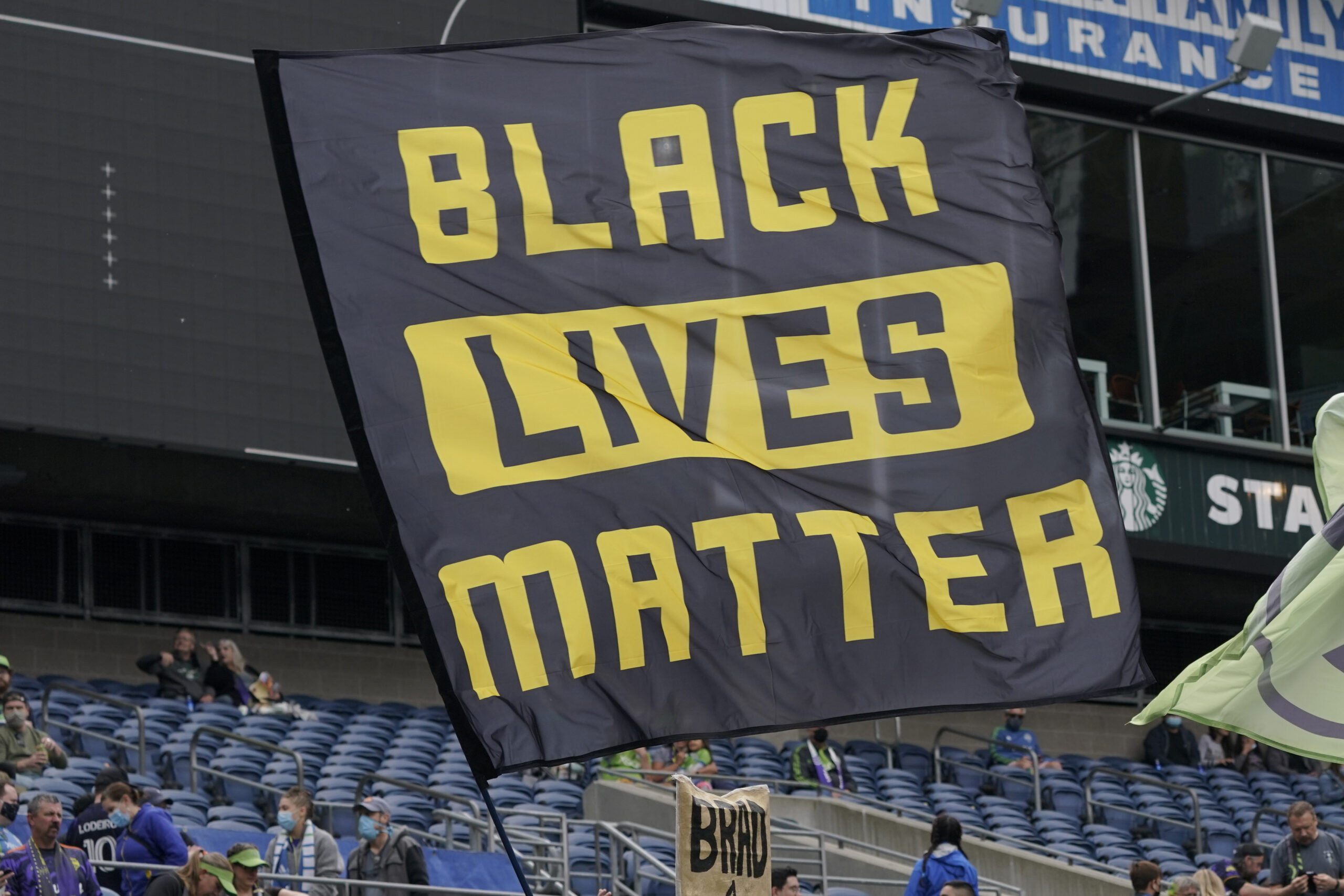 FILE - Seattle Sounders supporters fly a Black Lives Matter flag before an MLS soccer match against...