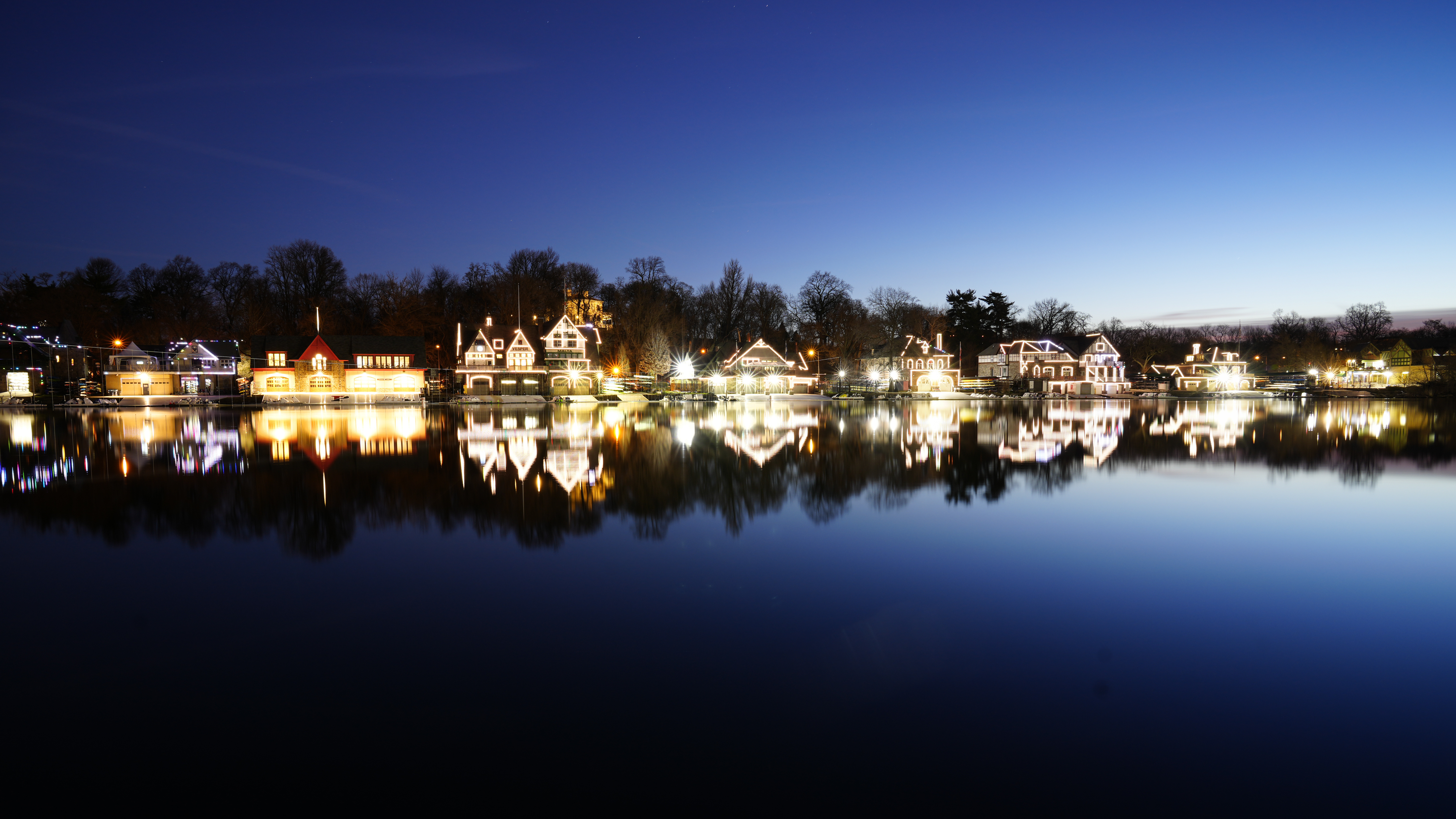 Lights illuminate the outline of structures on Boathouse Row along the banks of the Schuylkill Rive...