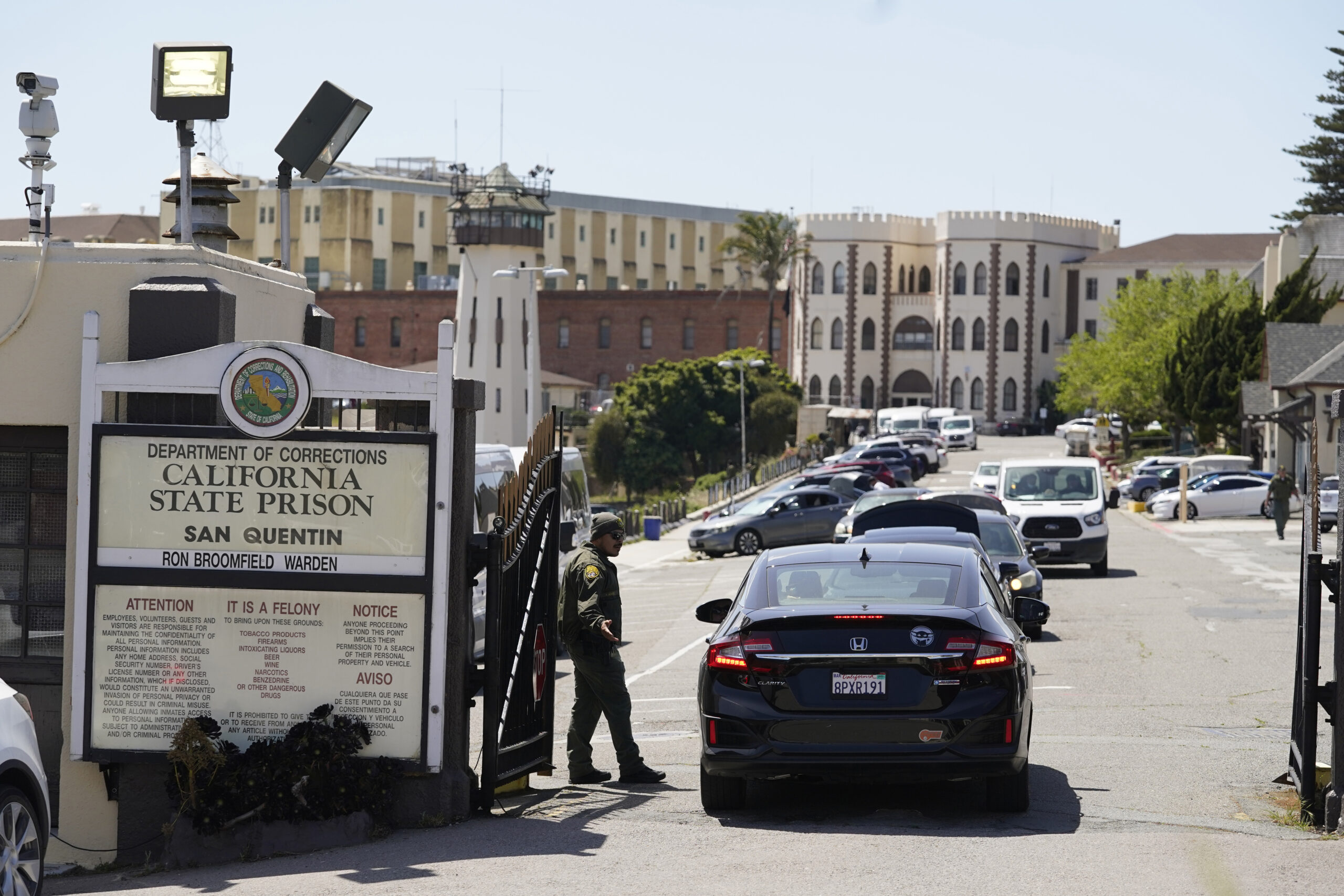 FILE - A guard checks vehicles entering the main gate at San Quentin State Prison on April 12, 2022...