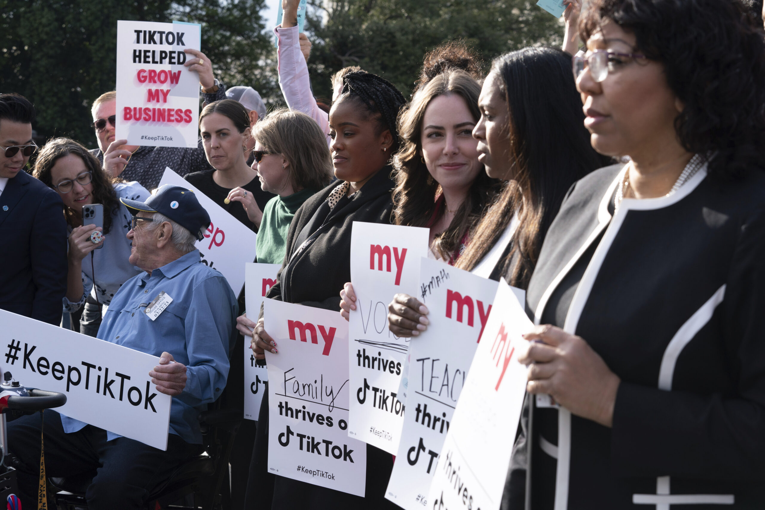 Supporters of TikTok hold signs during a rally to defend the app, Wednesday, March 22, 2023, at the...