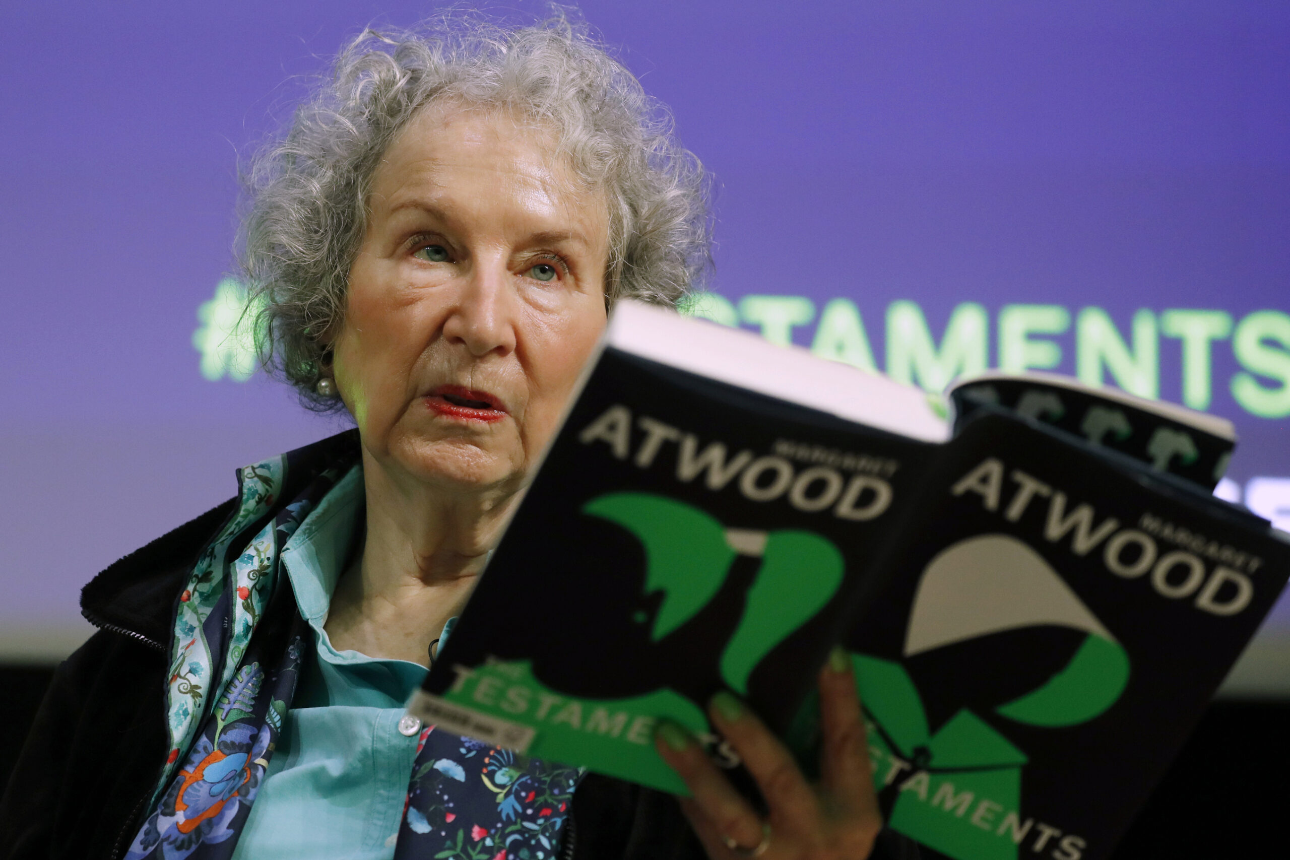 FILE - Canadian author Margaret Atwood holds a copy of her book "The Testaments," during a news con...