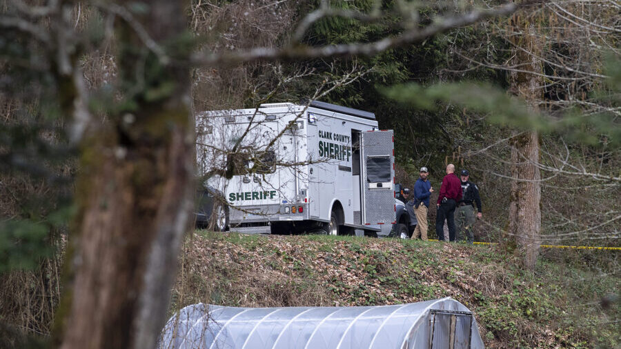 Law enforcement officials work at the scene along Wooding Road on Wednesday, March 22, 2023, east o...