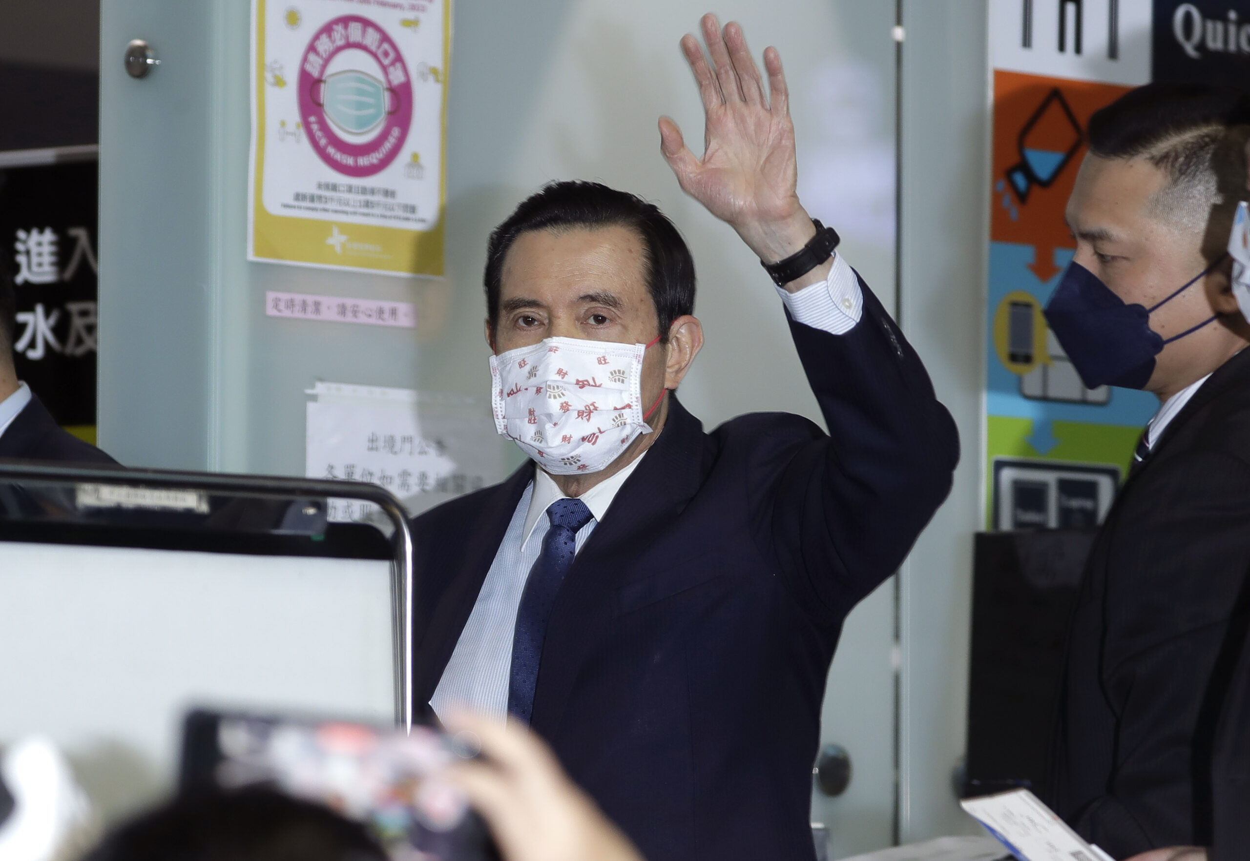 Former Taiwan President Ma Ying-jeou waves as Ma leaves for China, at Taoyuan International Airport...