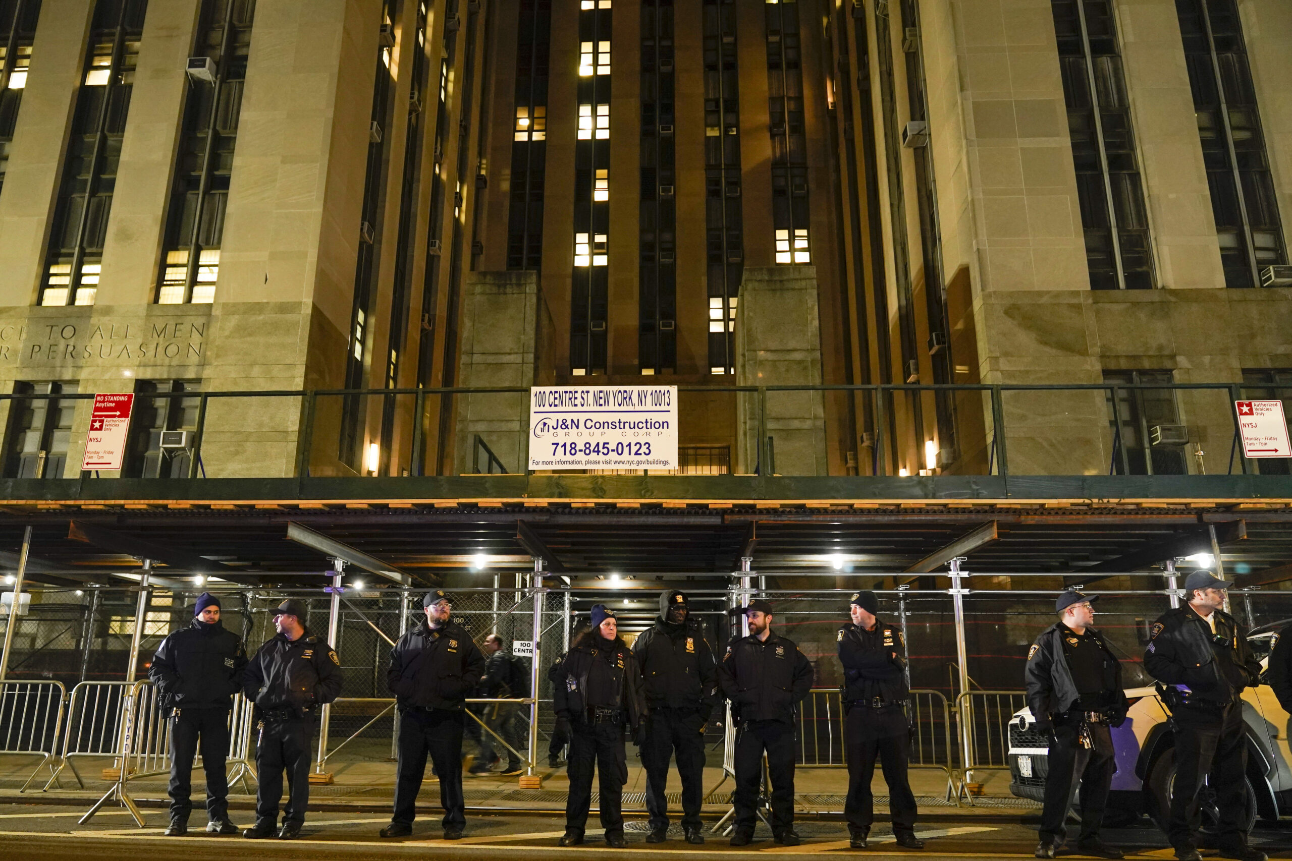 Court officers stand guard outside the Manhattan criminal courts building, Thursday, March 30, 2023...