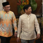 
              Philippine President Ferdinand Marcos Jr., right, walks with Malaysia's Prime Minister Anwar Ibrahim after delivering their statements to the press at the Malacanang presidential palace in Manila, Philippines on Wednesday Mar. 1, 2023. (AP Photo/Aaron Favila, Pool)
            
