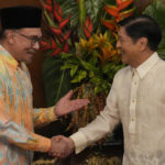 
              Philippine President Ferdinand Marcos Jr., right, shakes hands with Malaysia's Prime Minister Anwar Ibrahim after delivering their statements to the press at the Malacanang presidential palace in Manila, Philippines on Wednesday Mar. 1, 2023. (AP Photo/Aaron Favila, Pool)
            