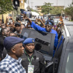 
              FILE - Presidential candidate Bola Tinubu of the All Progressives Congress gestures to supporters after casting his vote in the presidential elections in Lagos, Nigeria, Feb. 25, 2023. Election officials declared ruling party candidate Bola Tinubu the winner of Nigeria's presidential election early Wednesday, March 1, 2023, with the two leading opposition candidates already demanding a revote in Africa's most populous nation. (AP Photo/Ben Curtis, File)
            
