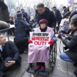 
              Yang Geum-deok, a South Korean victim of Japan's wartime forced labor, arrives at a rally against the South Korean government's move to improve relations with Japan in Seoul, South Korea, Wednesday, March 1, 2023. South Korea's president on Wednesday called Japan "a partner that shares the same universal values" and renewed hopes to repair ties frayed over Japan's colonial rule of the Korean Peninsula. The banner reads "South Korean President Yoon Suk Yeol's humiliation diplomacy." (AP Photo/Ahn Young-joon)
            