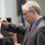 
              Prosecutor Creighton Waters holds up a composite sketch Alex Murdaugh helped make during closing arguments in Murdaugh's double murder trial at the Colleton County Courthouse on Wednesday, March 1, 2023, in Walterboro, S.C. The 54-year-old attorney is standing trial on two counts of murder in the shootings of his wife and son at their Colleton County home and hunting lodge on June 7, 2021. (Joshua Boucher/The State via AP, Pool)
            