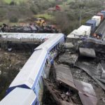 
              A crane, firefighters and rescuers operate after a collision in Tempe, about 376 kilometres (235 miles) north of Athens, near Larissa city, Greece, Wednesday, March 1, 2023. A train carrying hundreds of passengers has collided with an oncoming freight train in northern Greece, killing and injuring dozens passengers. (AP Photo/Vaggelis Kousioras)
            