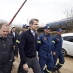 In this photo provided by the Greek Prime Minister's Office, Greece's Prime Minister Kyriakos Mitsotakis, second left, accompanied by Transport Minister Kostas Karamanlis, left, visit the location of train collision in Tempe, about 376 kilometres (235 miles) north of Athens, near Larissa city, Greece, Wednesday, March 1, 2023. A passenger train carrying hundreds of people, including many university students returning home from holiday, has collided at high speed with an oncoming freight train. (Dimitris Papamitsos/Greek Prime Minister's Office via AP)