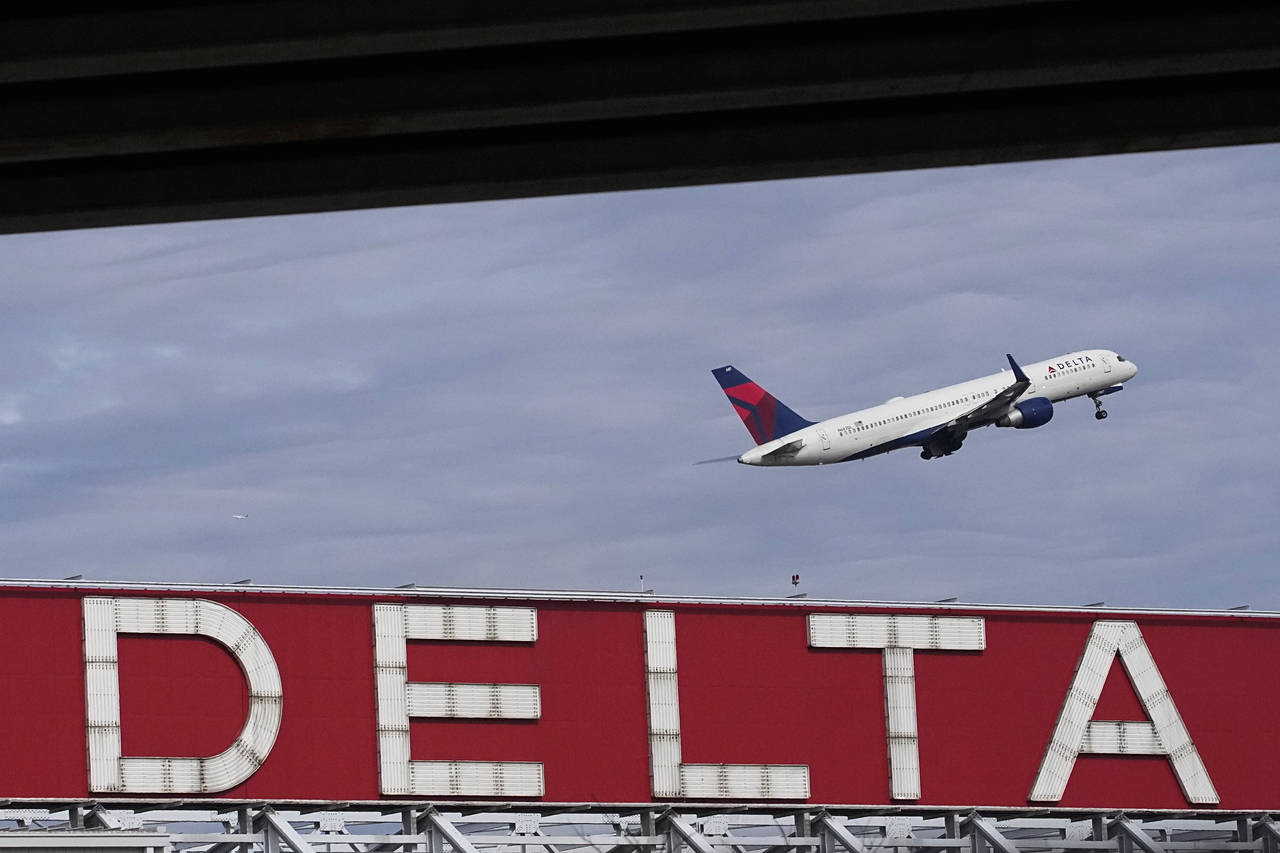 FILE - A Delta Air Lines plane takes off from Hartsfield-Jackson Atlanta International Airport in A...