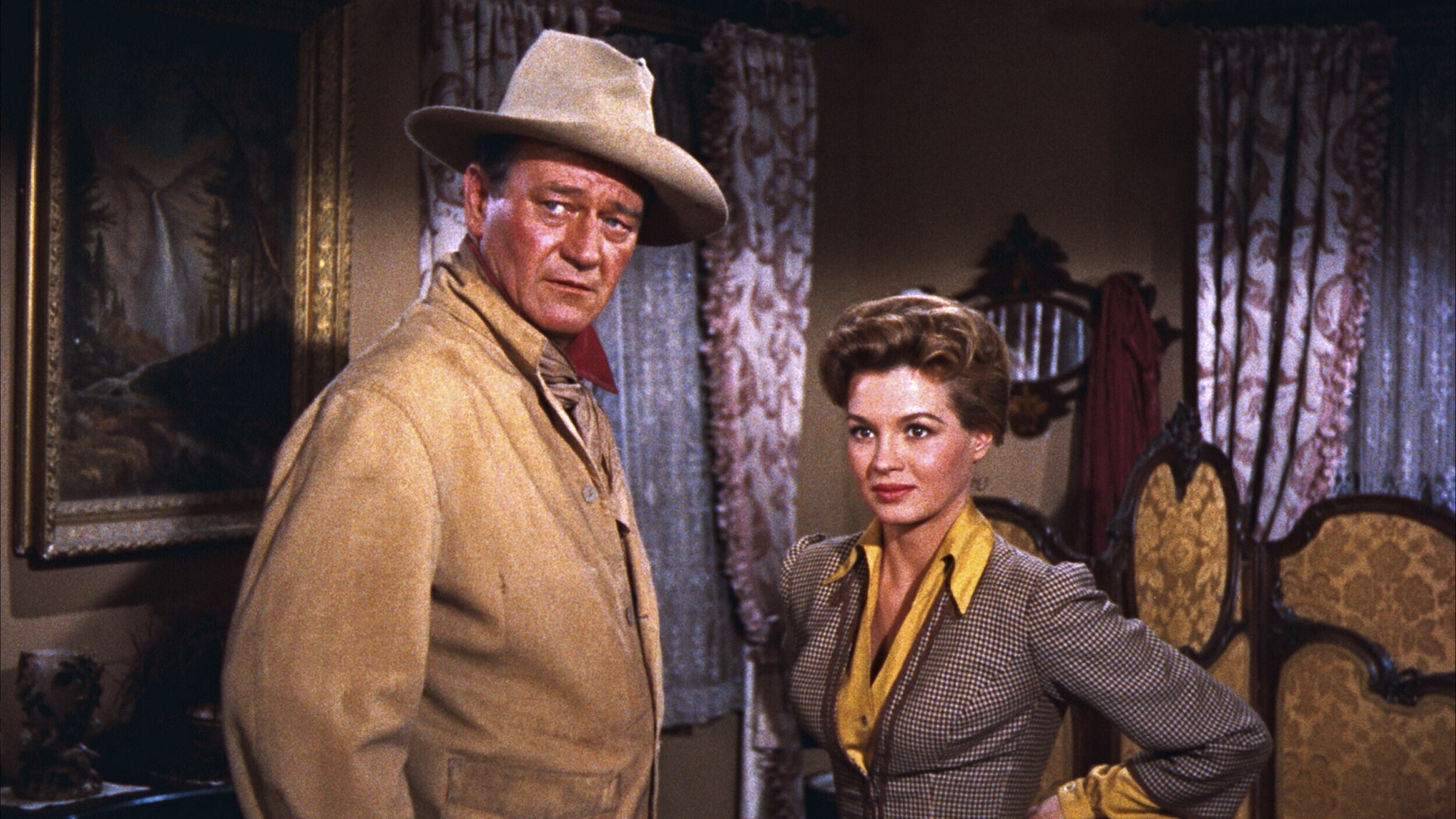 This image released by Warner Bros. Entertainment shows John Wayne as Sheriff John T. Chance, left,...