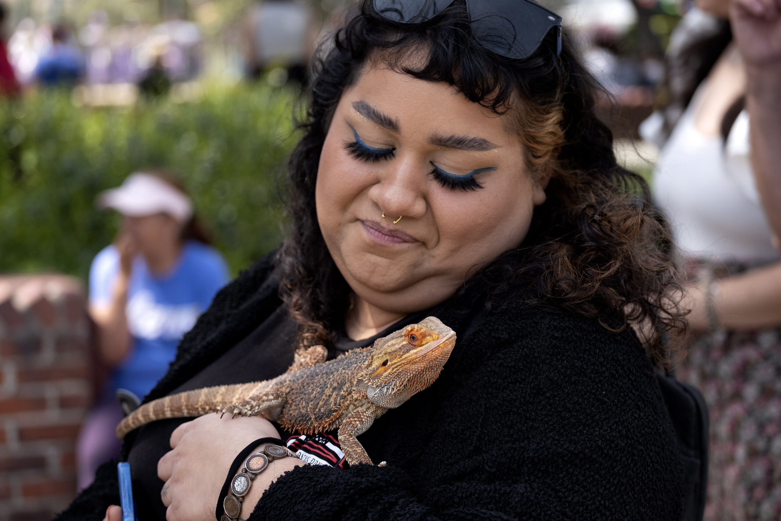Jennifer Guerra waits in line with her bearded dragon named Daddy for the traditional blessing of t...