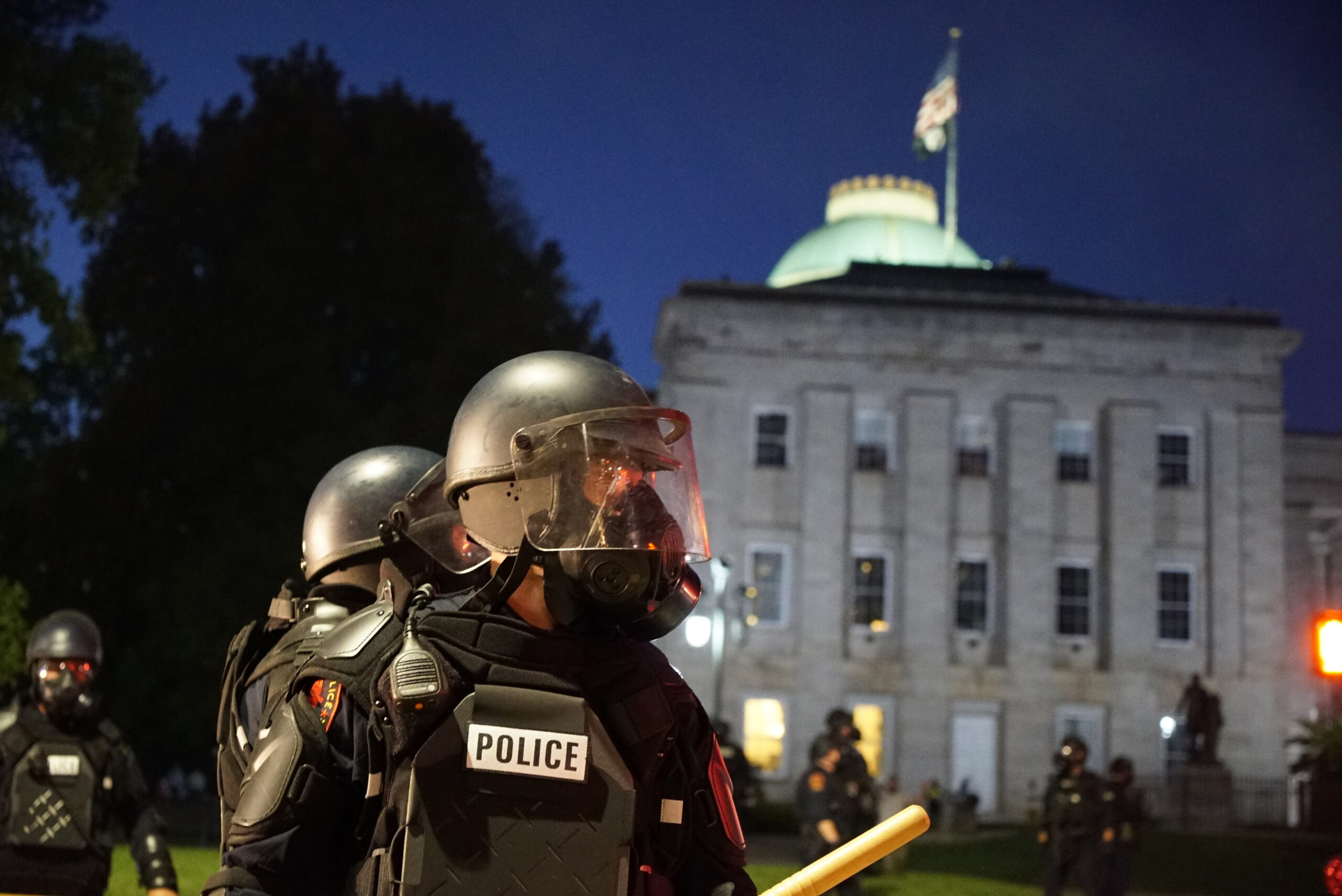 FILE - Police in riot gear protect the old state capitol building in Raleigh, N.C., on May 31, 2020...