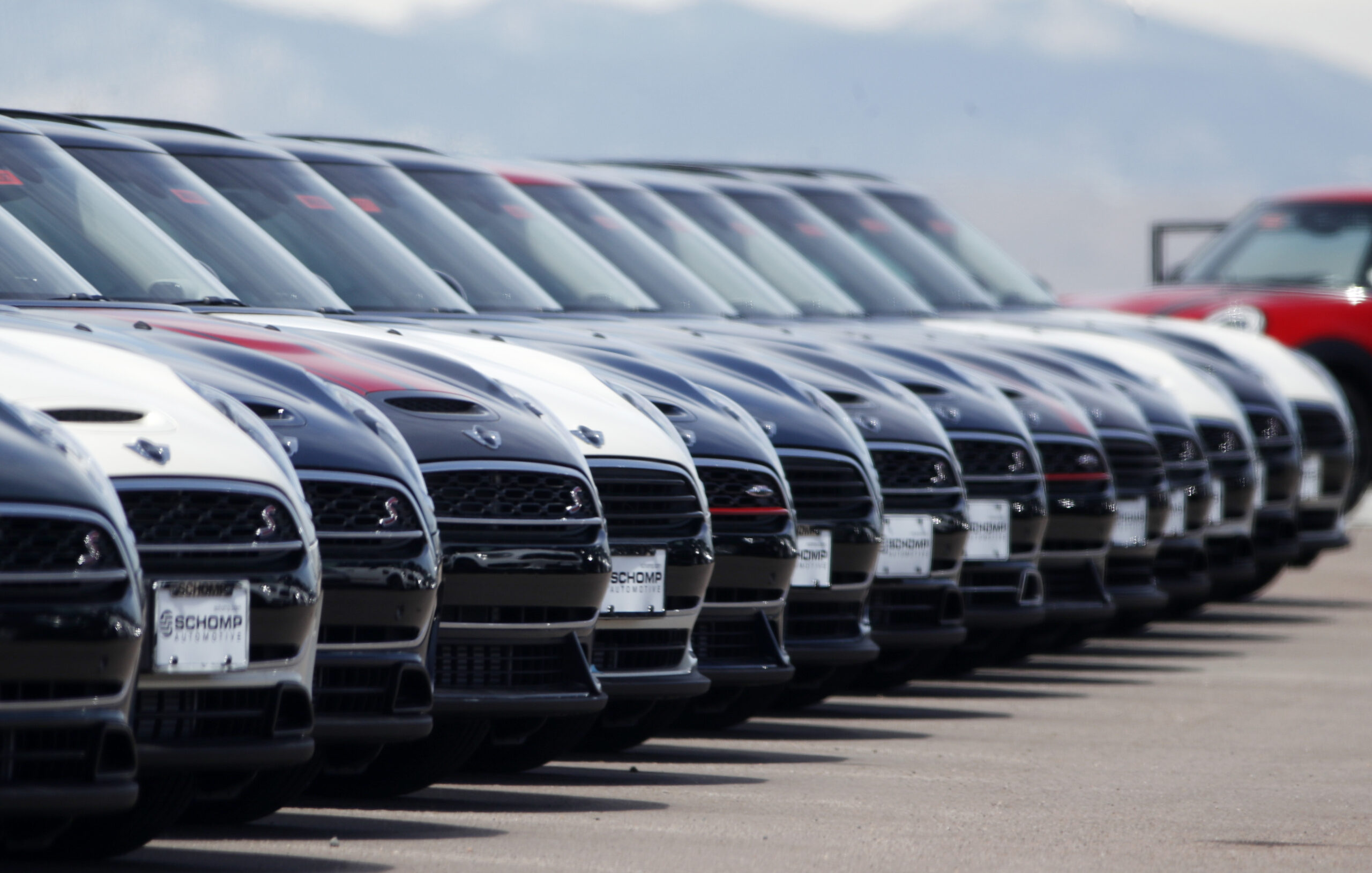 FILE - A line of unsold 2018 Cooper Clubmen sit in a long row at a Mini dealership, March 30, 2018,...