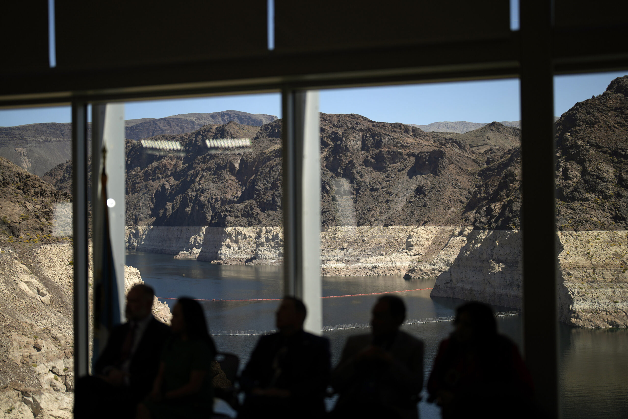 FILE - Officials listen during a news conference on Lake Mead at the Hoover Dam Tuesday, April 11, ...