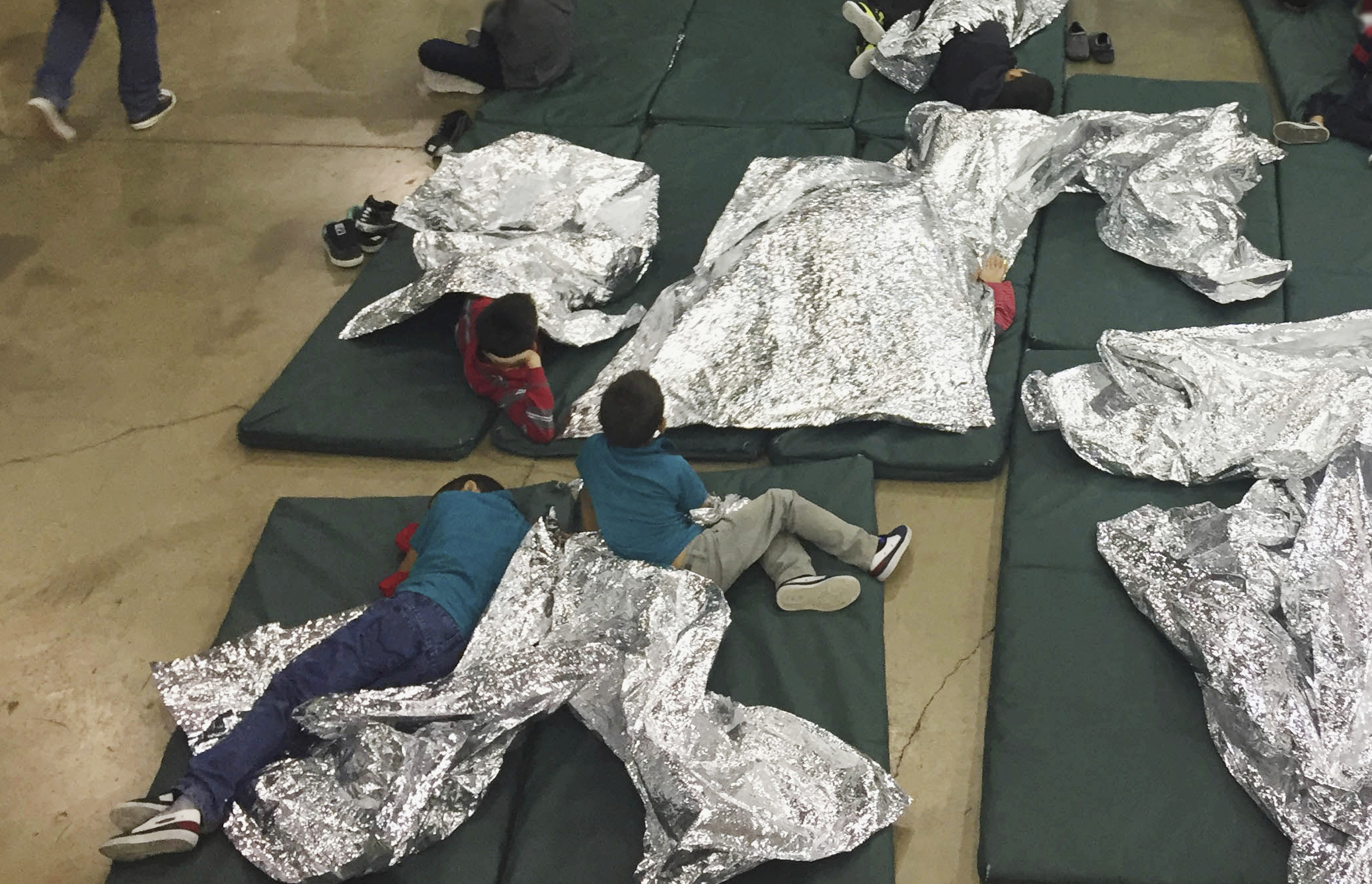 FILE - In this photo provided by U.S. Customs and Border Protection, people who've been taken into ...