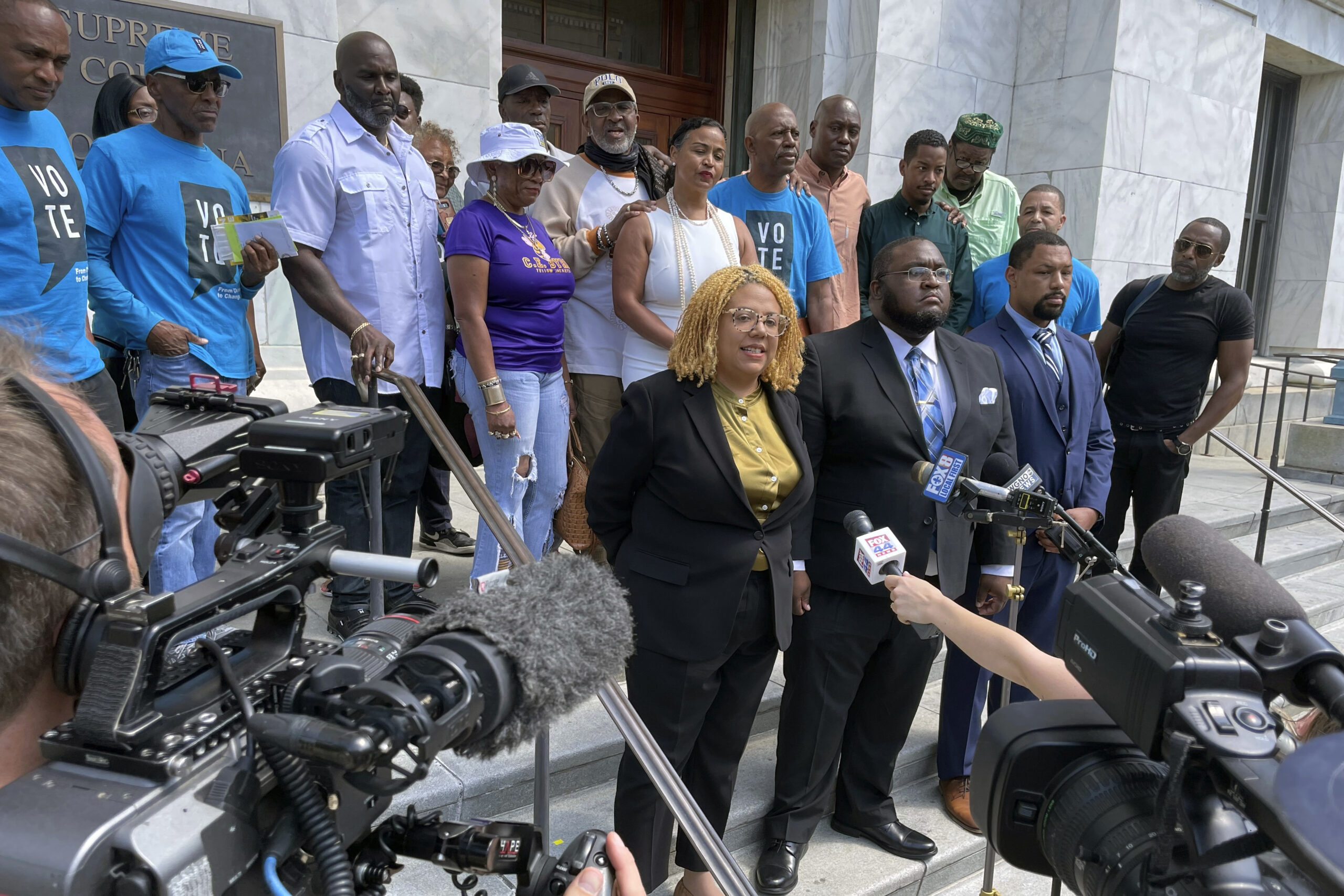 FILE - Attorneys and criminal justice advocates stand outside Louisiana's Supreme Court on May 10, ...