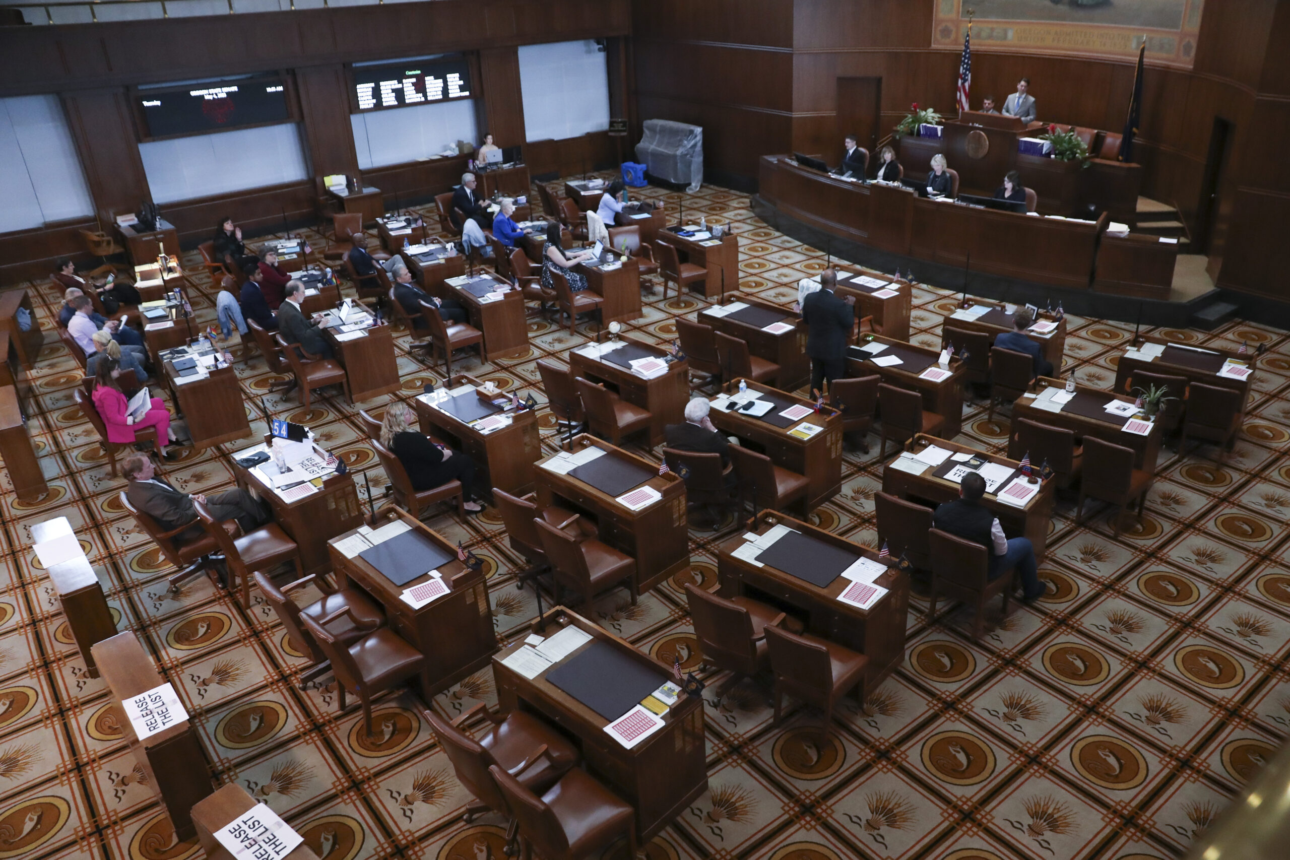 Senators sit at their desks during a session at the Oregon State Capitol in Salem, Ore., Thursday, ...