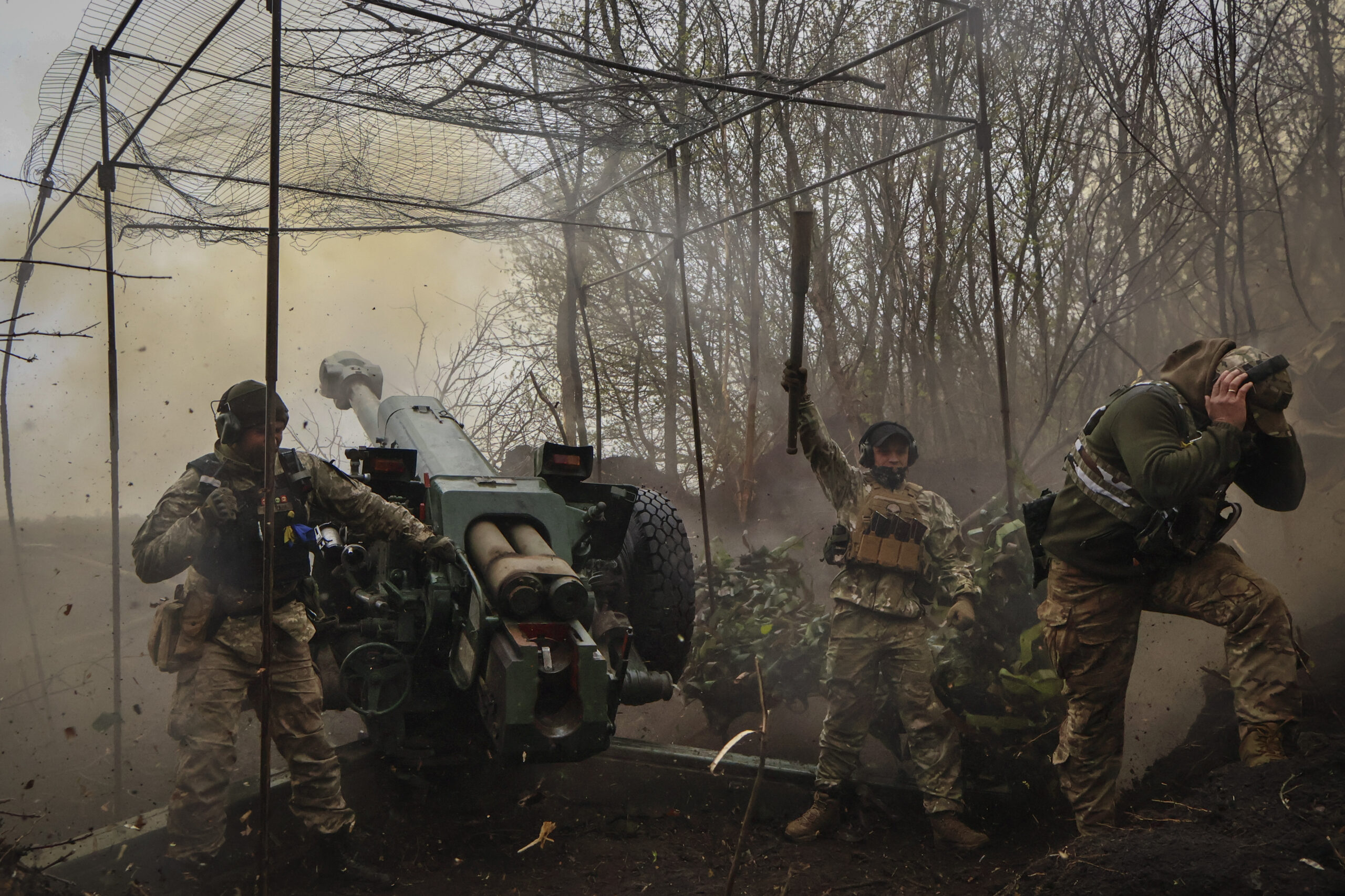 FILE - Ukrainian soldiers fire a howitzer D-30 at the frontline near Bakhmut, Donetsk region, Ukrai...