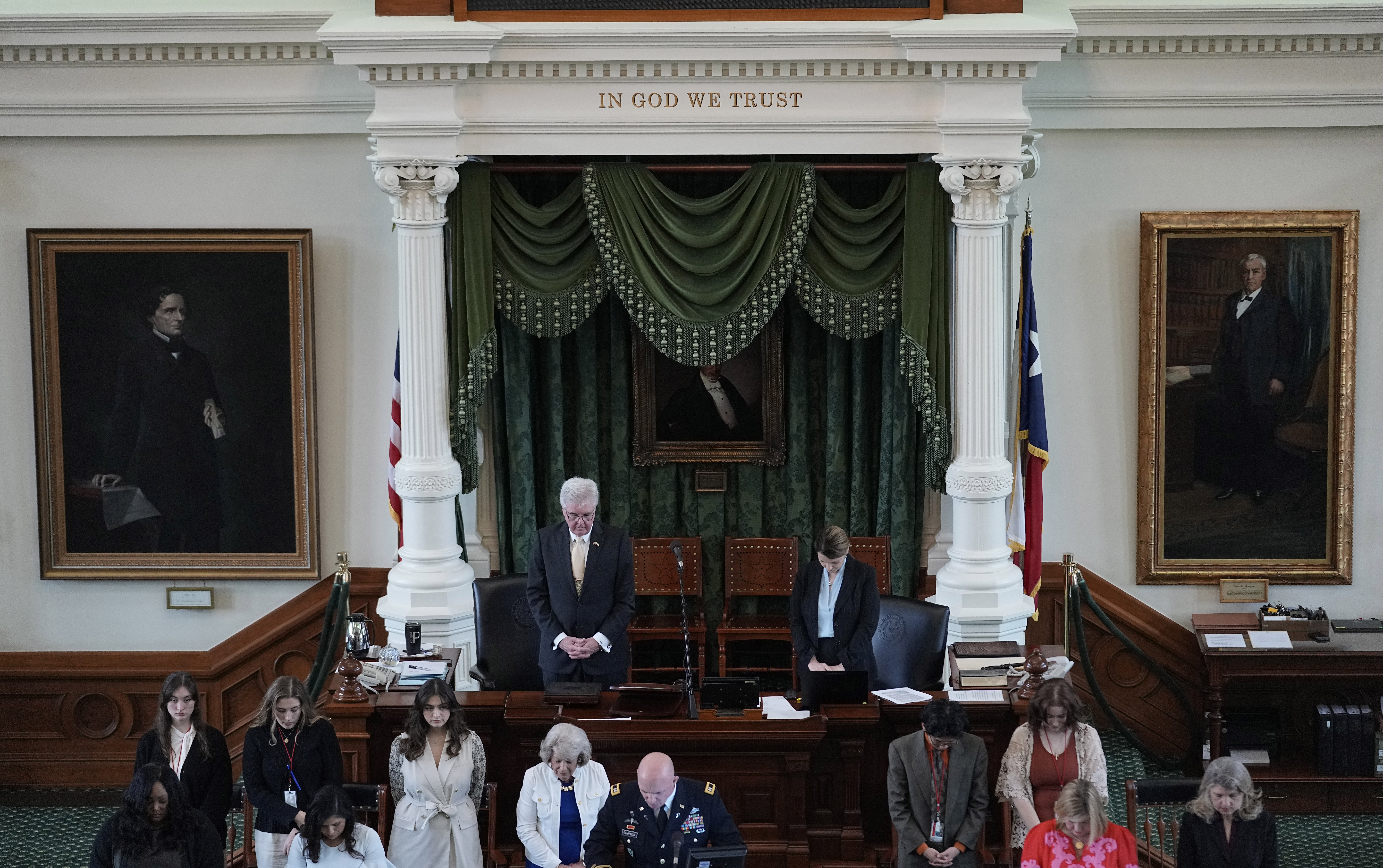 Texas Lt. Gov. Dan Patrick, top left, bows for prayer in the Senate Chamber at the Texas Capitol in...