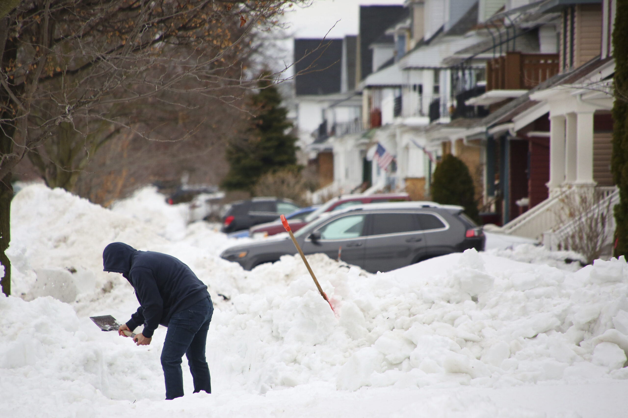 FILE - A person removes snow from the front of his driveway a few days after a winter storm rolled ...