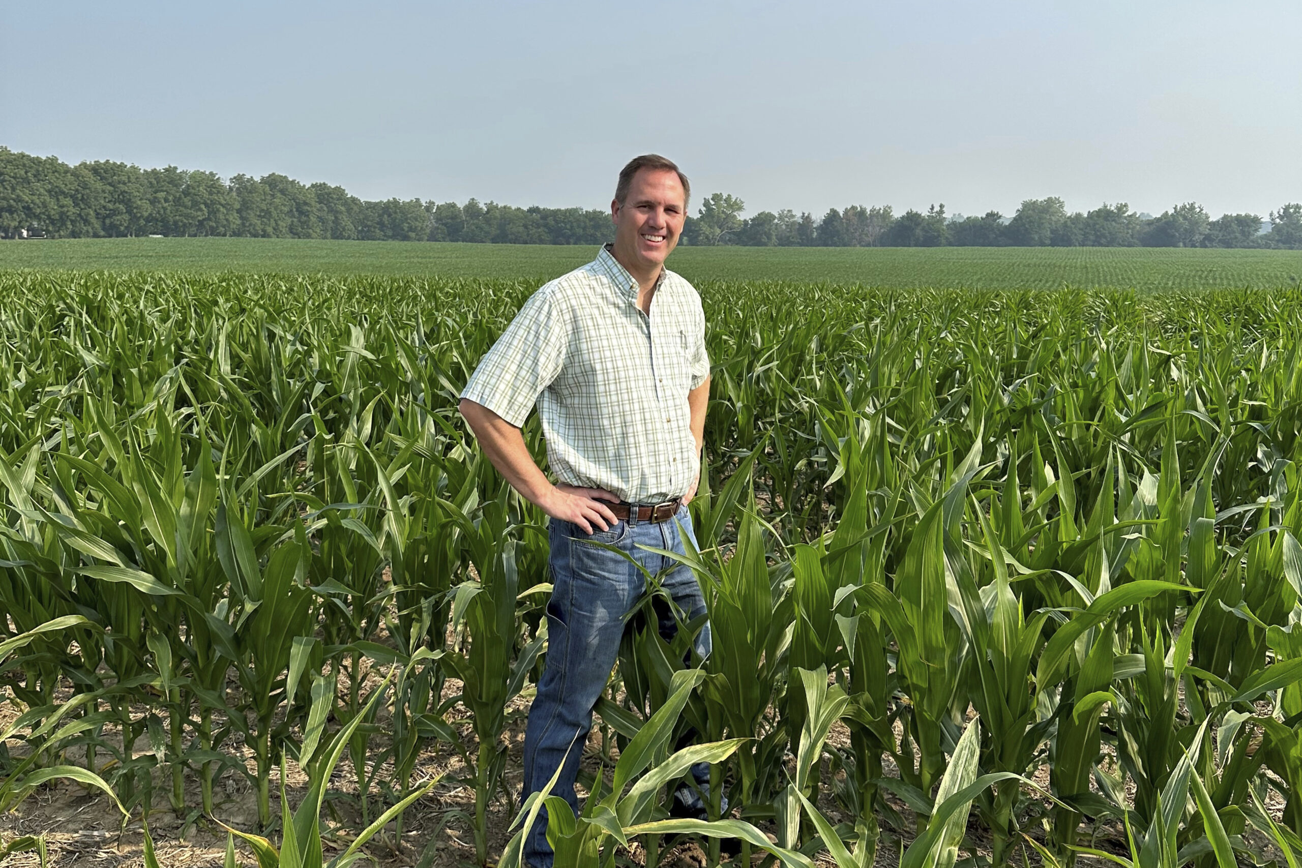 This photo provided by Mike Shane shows Shane as he stands in his corn field near Peoria, Ill., Tue...