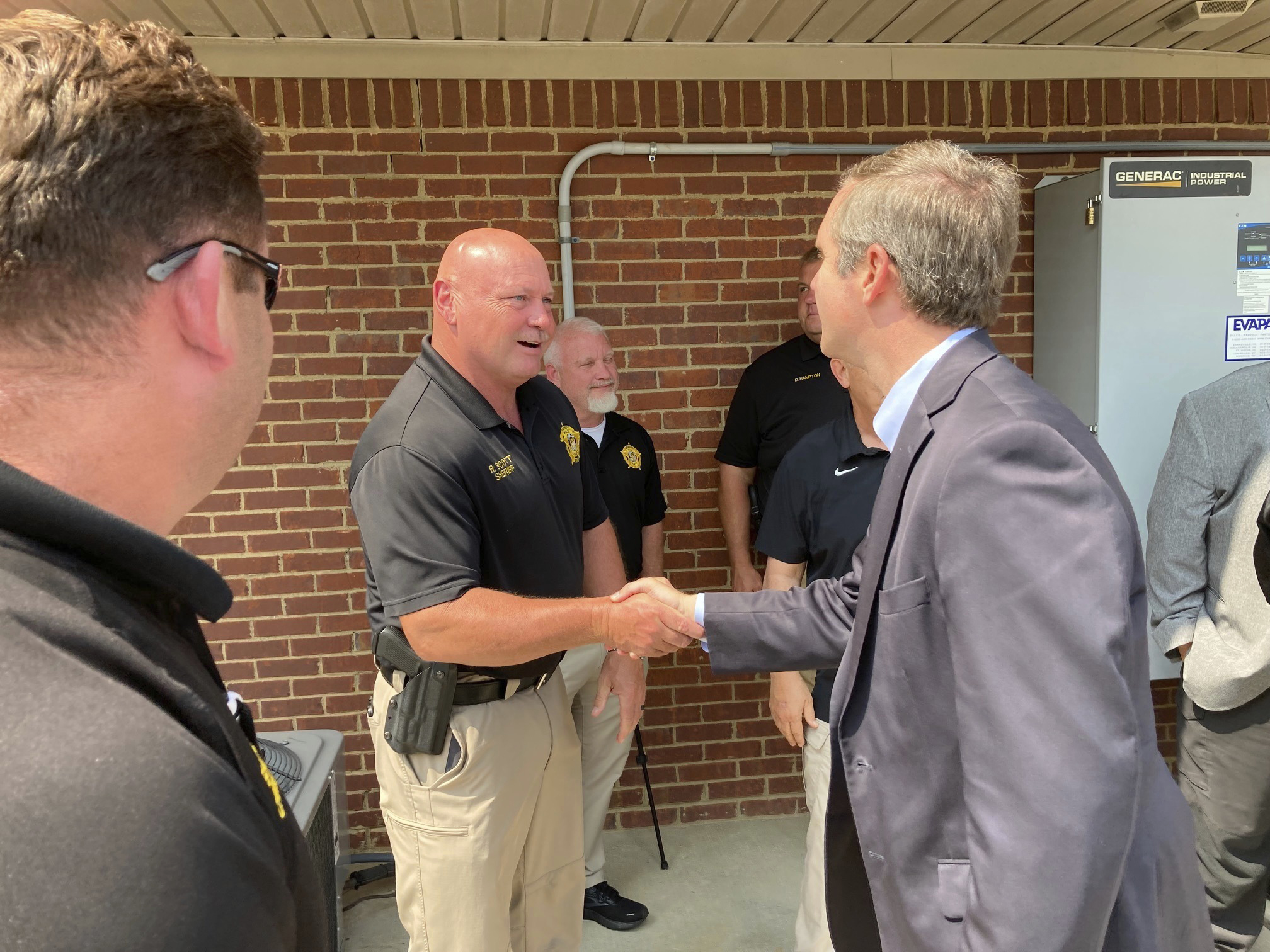 Kentucky Gov. Andy Beshear, right, greets law enforcement officers at a campaign event on Tuesday, ...