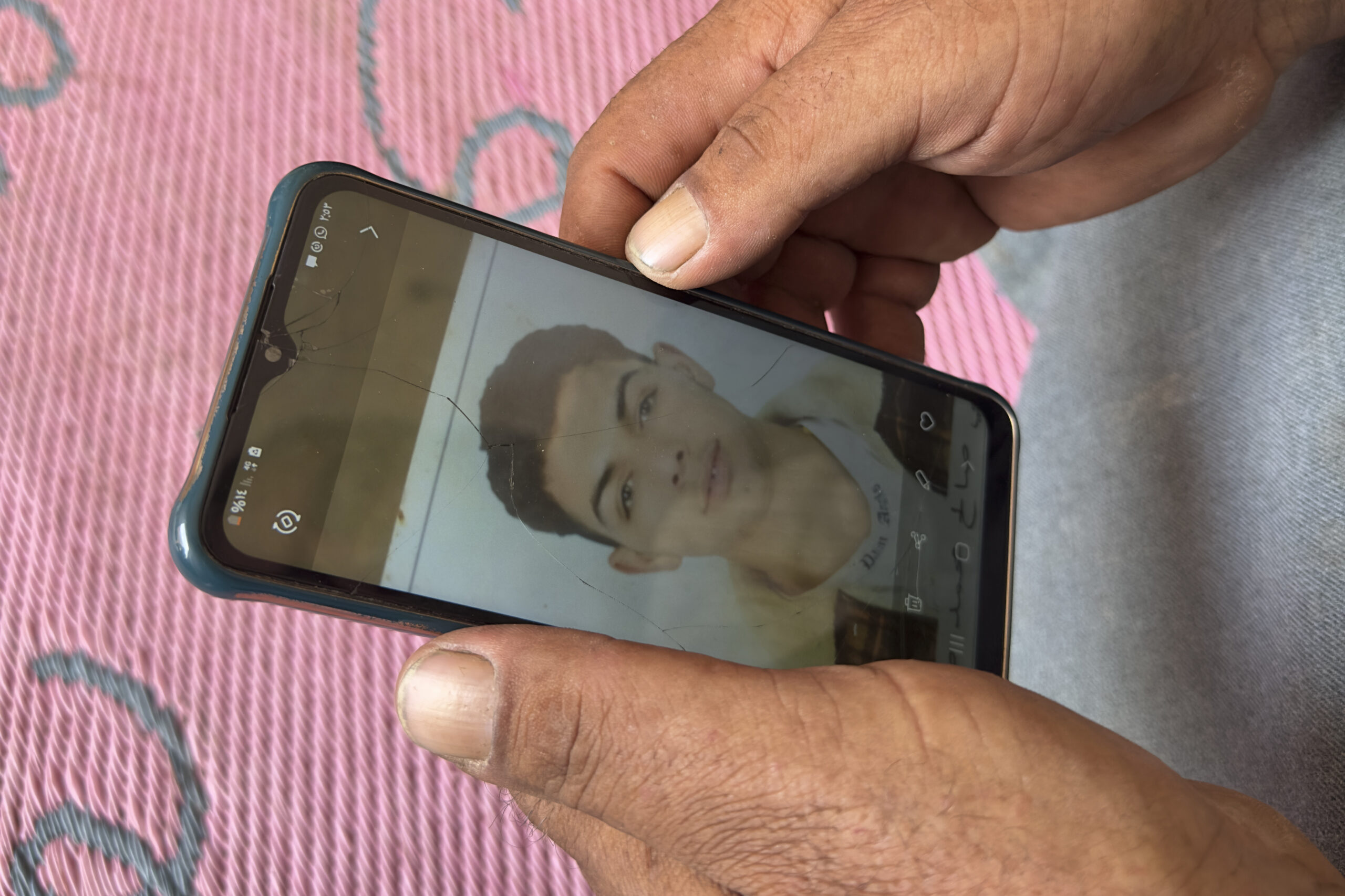 Saleh: Mohammed Saleh, the father of 18-year-old Yahia Saleh, holds a phone with a photo of his son...