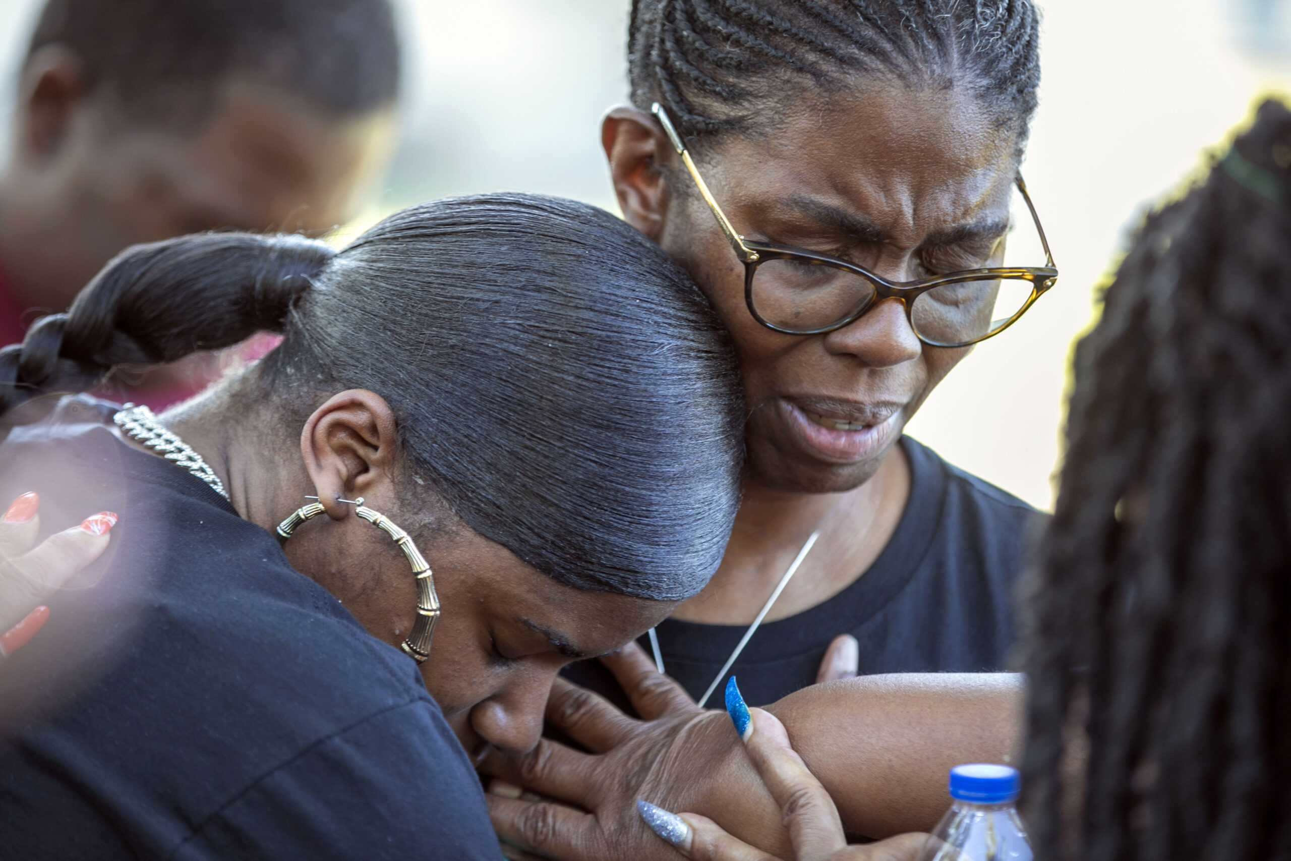 Tmika Wilkerson, left, and Kimberly Wilkerson pray as mourners gather for a remembrance service at ...