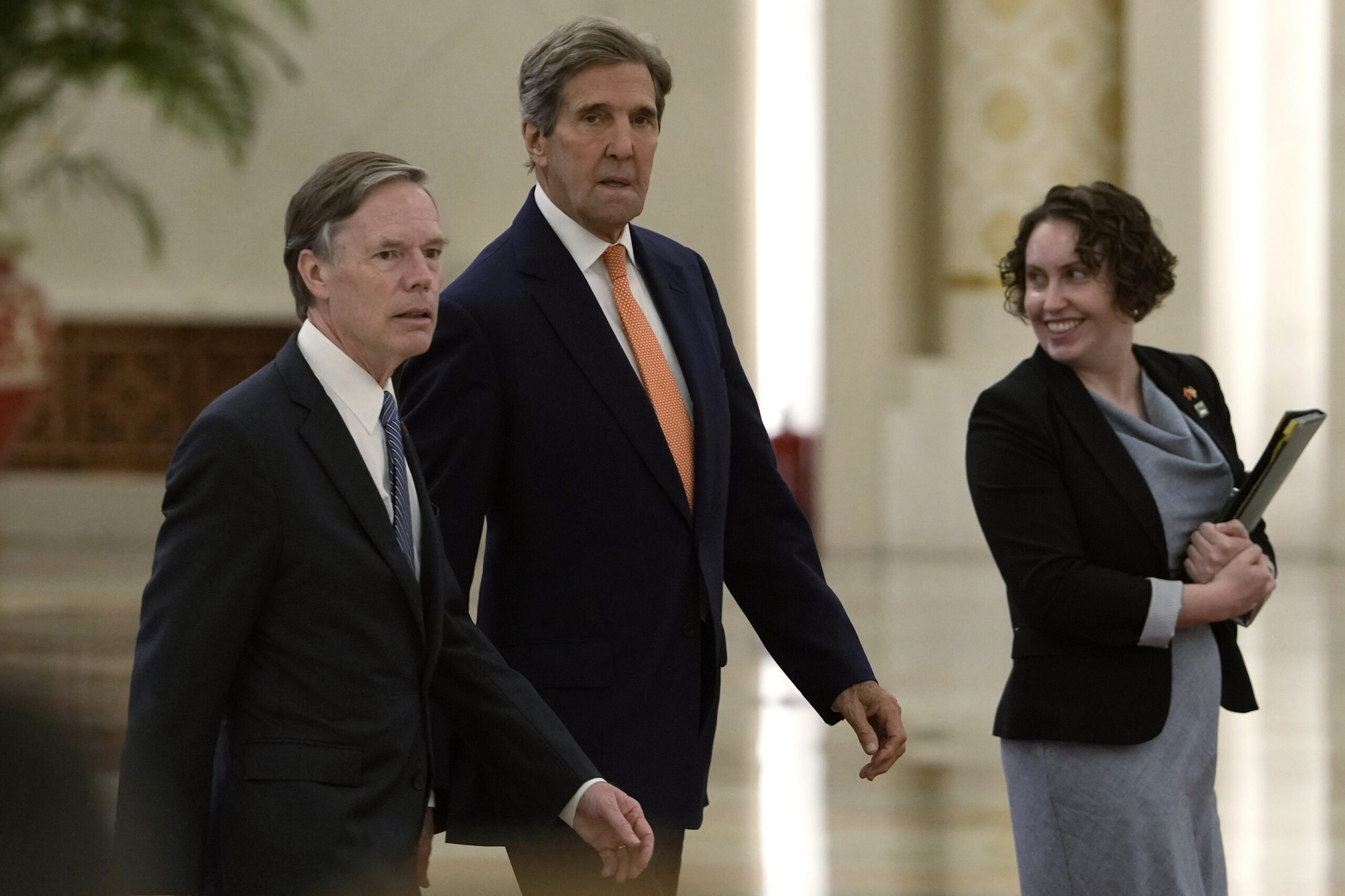 U.S. climate envoy John Kerry, center, walks next to U.S. Ambassador to China Nicholas Burns as the...