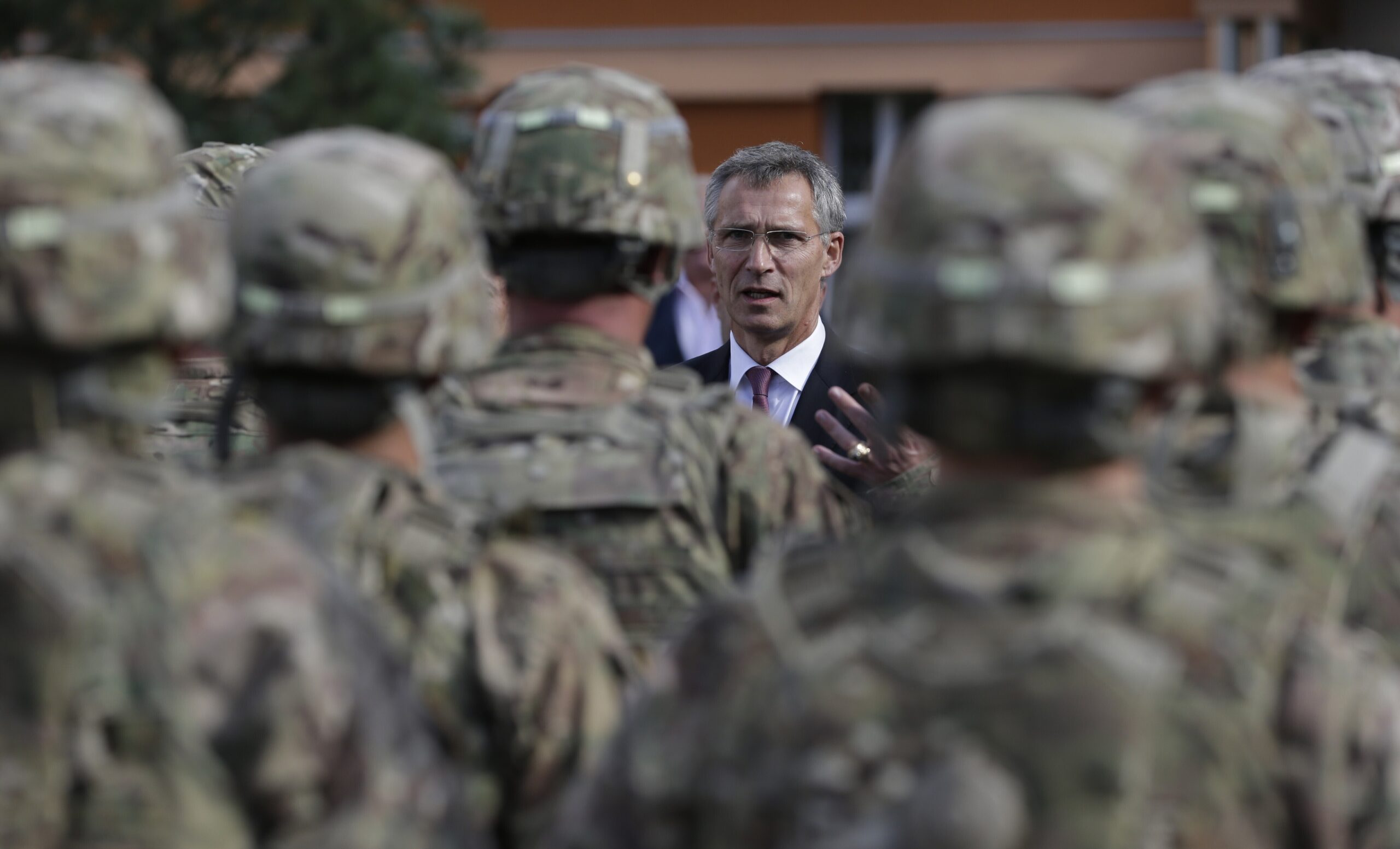 FILE - NATO Secretary General Jens Stoltenberg talks to US army soldiers while visiting Prague, Cze...
