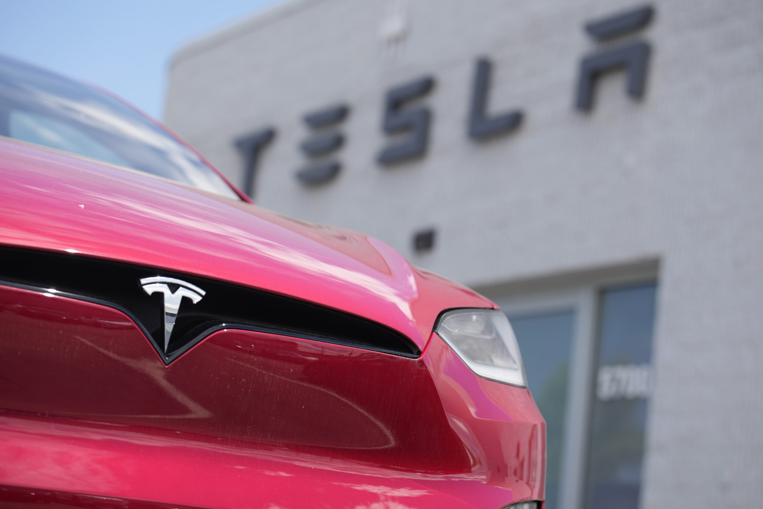 An unsold 2023 Model X sports-utility vehicle sits outside a Tesla dealership Sunday, June 18, 2023...