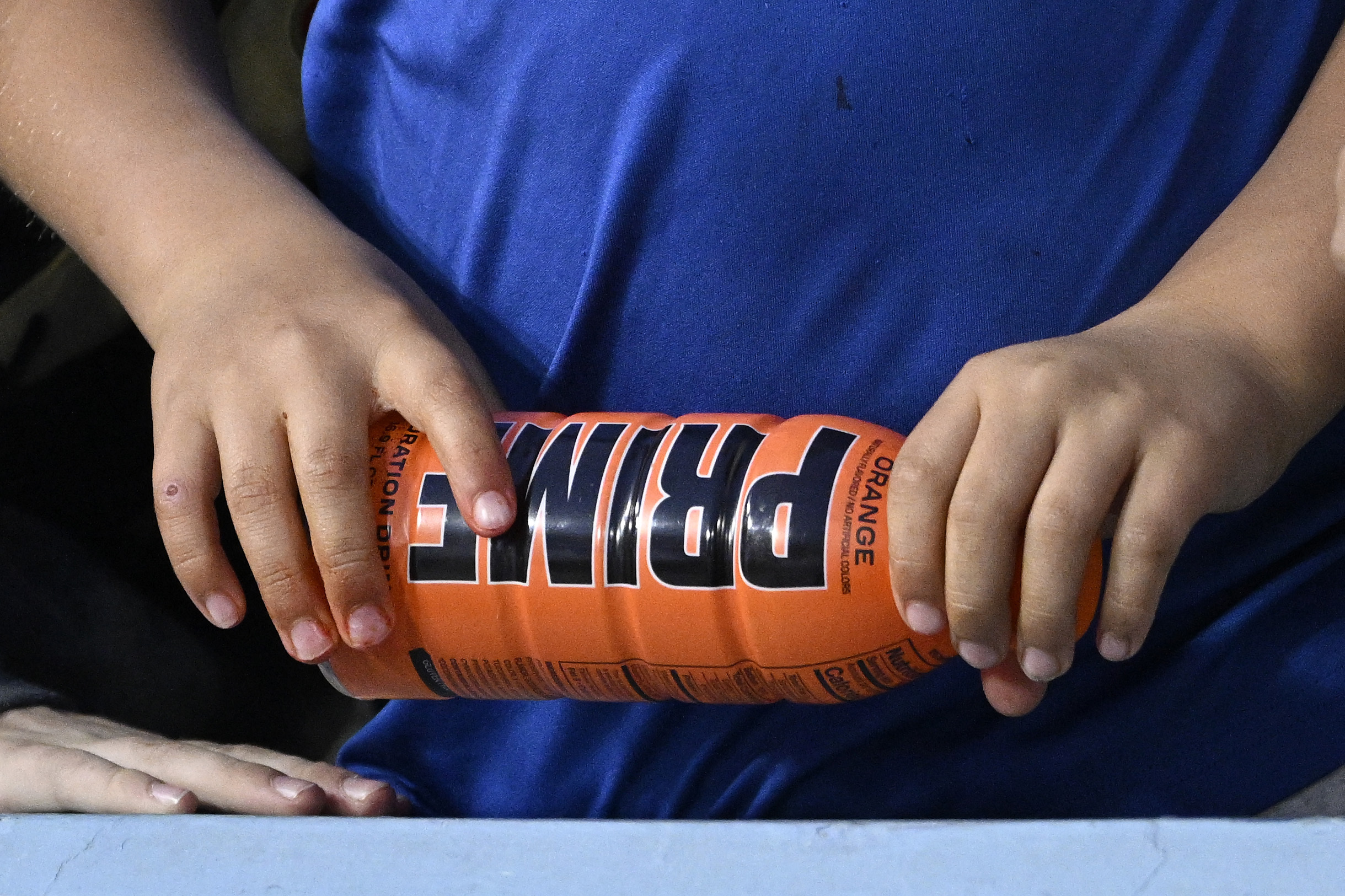 FILE - A child holds a PRIME hydration drink prior to a baseball game between the Los Angeles Dodge...