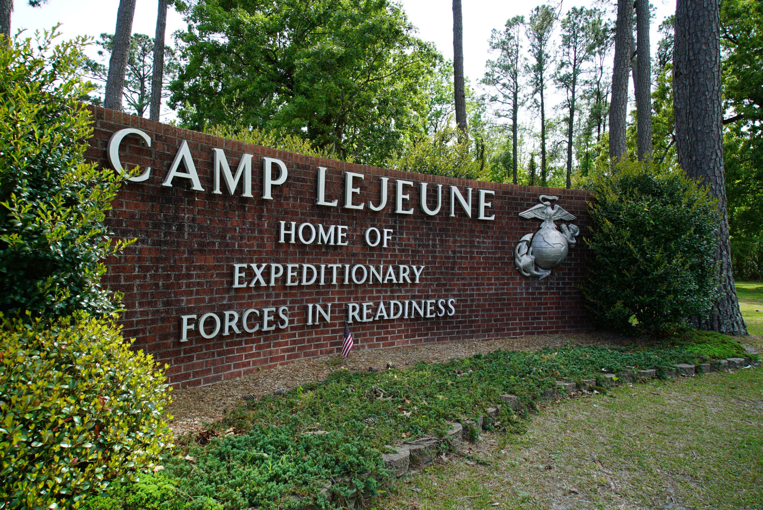 FILE - Signage stands on the main gate to Camp Lejeune Marine Base outside Jacksonville, N.C., Frid...