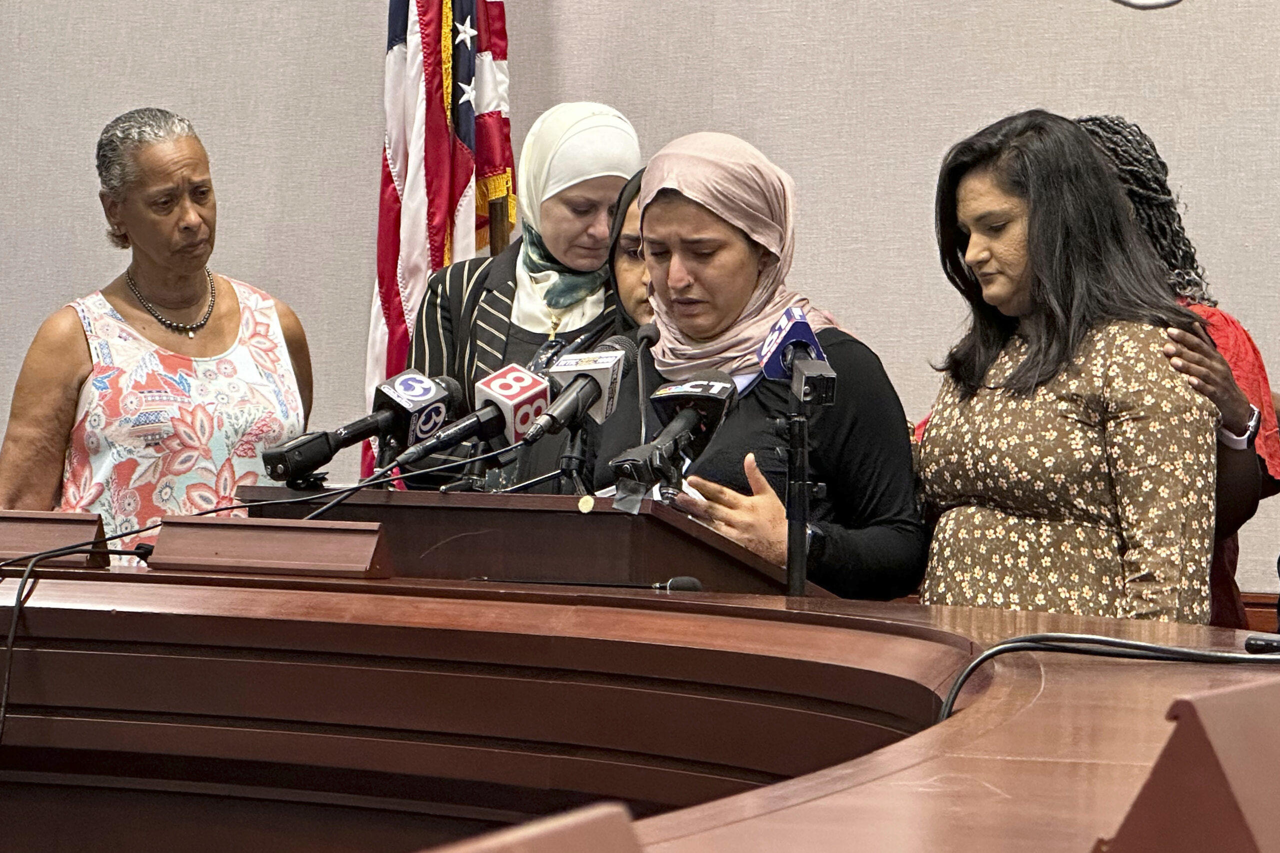 FILE - Connecticut state Rep. Maryam Khan, second from right, with her right arm in a sling and sur...