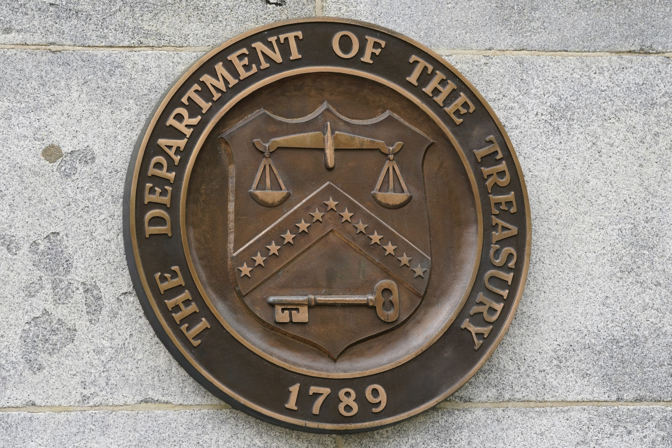 FILE - The Department of the Treasury's seal outside the Treasury Department building in Washington...