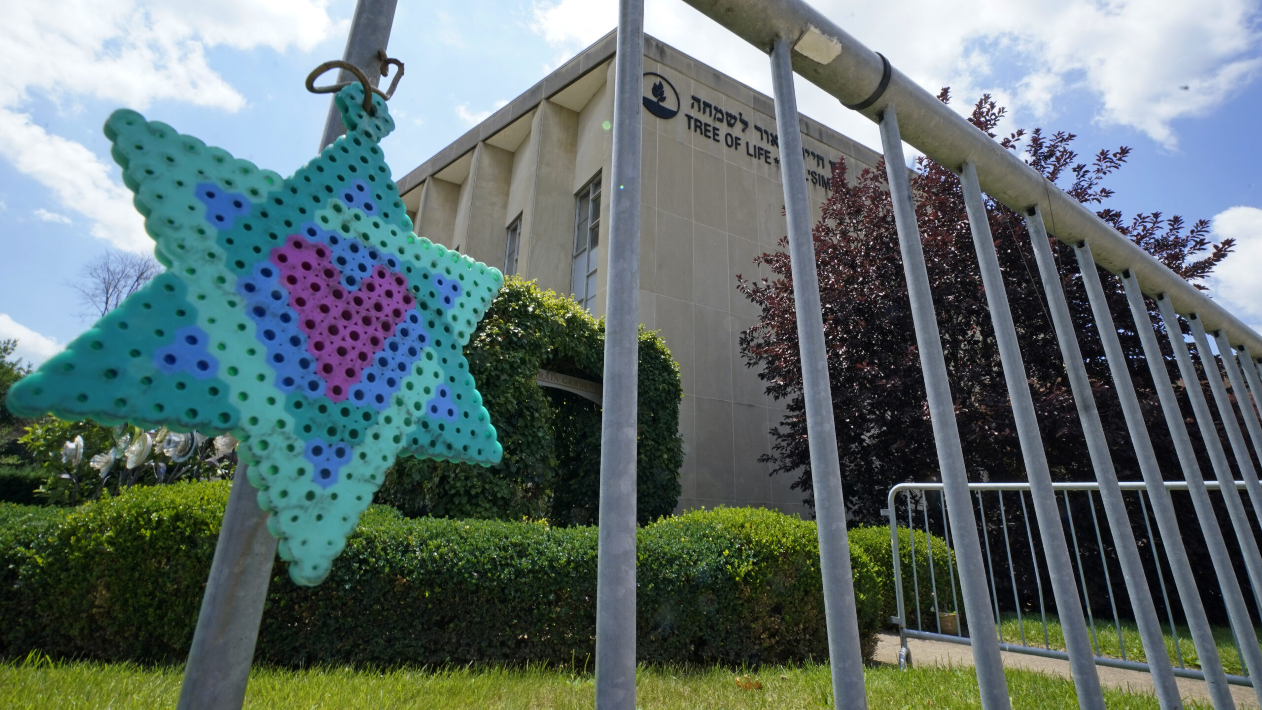 A Star of David hangs from a fence outside the dormant landmark Tree of Life synagogue in Pittsburg...