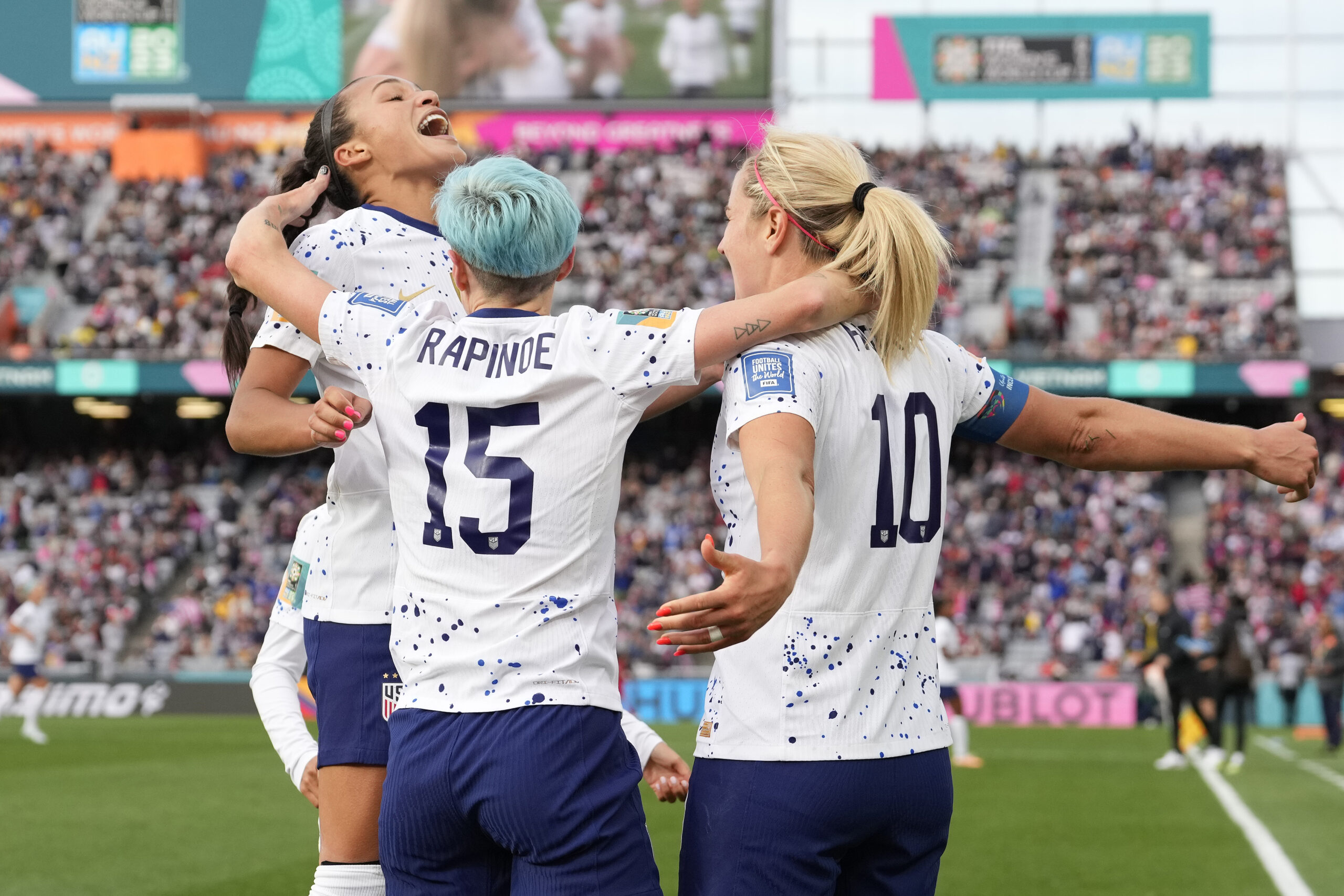 United States' Lindsey Horan, right, celebrates with Sophia Smith, left, and Megan Rapinoe after sc...