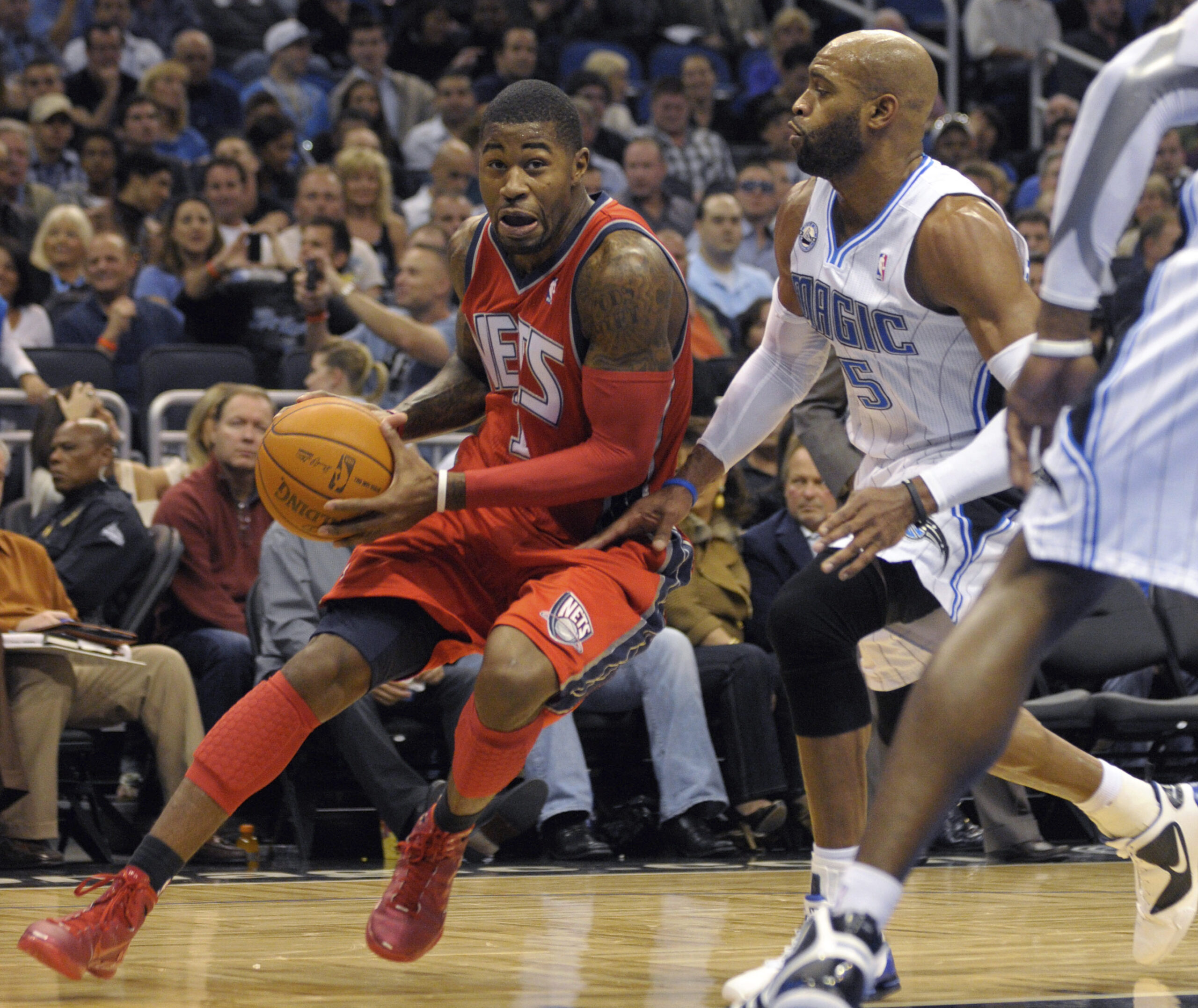 FILE - New Jersey Nets guard Terrence Williams, left, drives past Orlando Magic guard Vince Carter ...