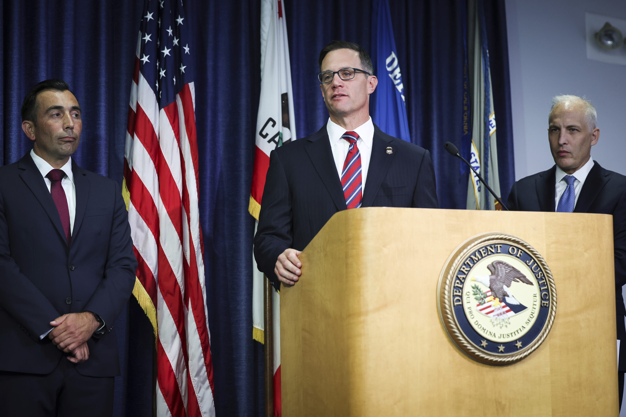 U.S. Attorney Randy S. Grossman for the Southern District of California, center, speaks during a pr...
